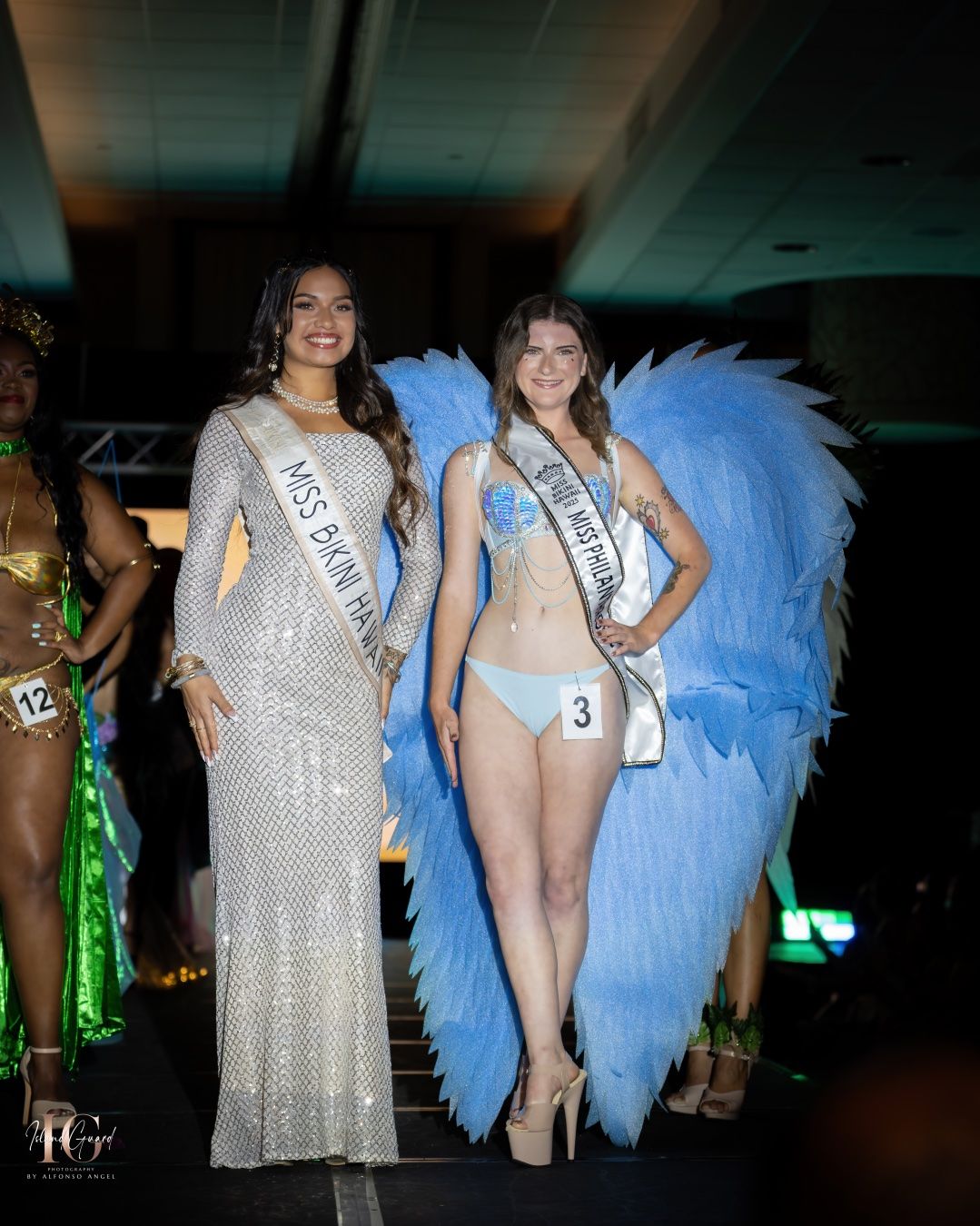 Pageant contestants line up on stage in glittery dresses and sashes during evening gown competition.