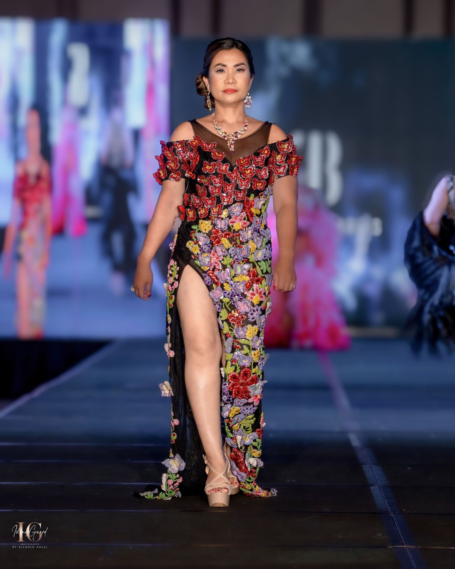 Floral printed mini dress with ruffled details showcased on illuminated catwalk.