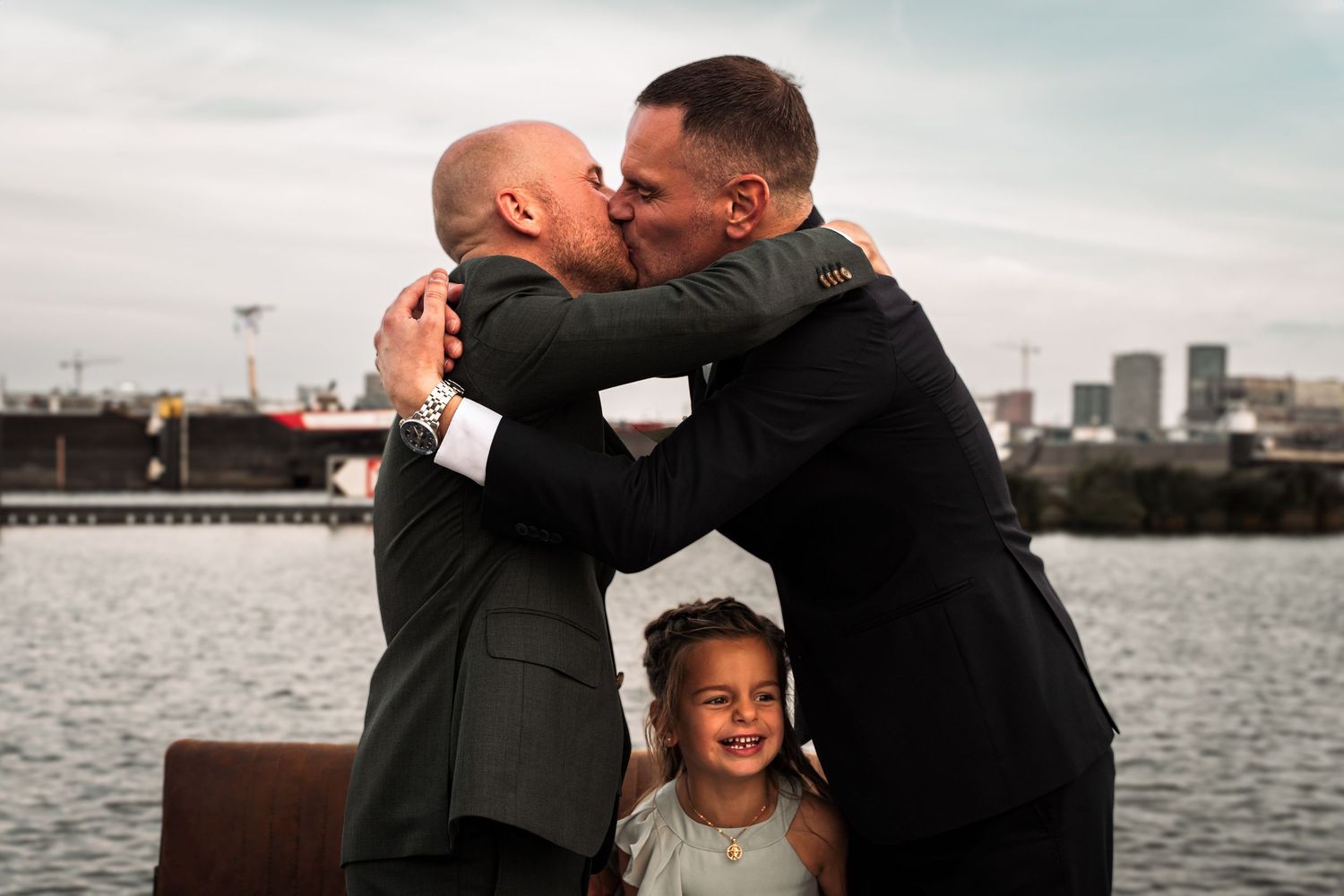A series of candid waterfront wedding moments showing emotional embraces and joyful celebrations by the harbor.