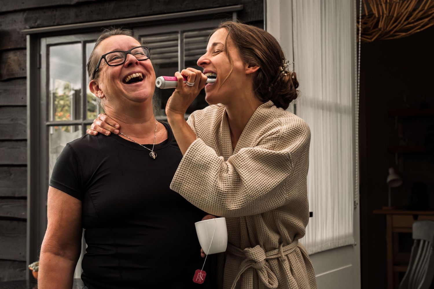 A candid series of joyful laughing moments captured in black and white photography.