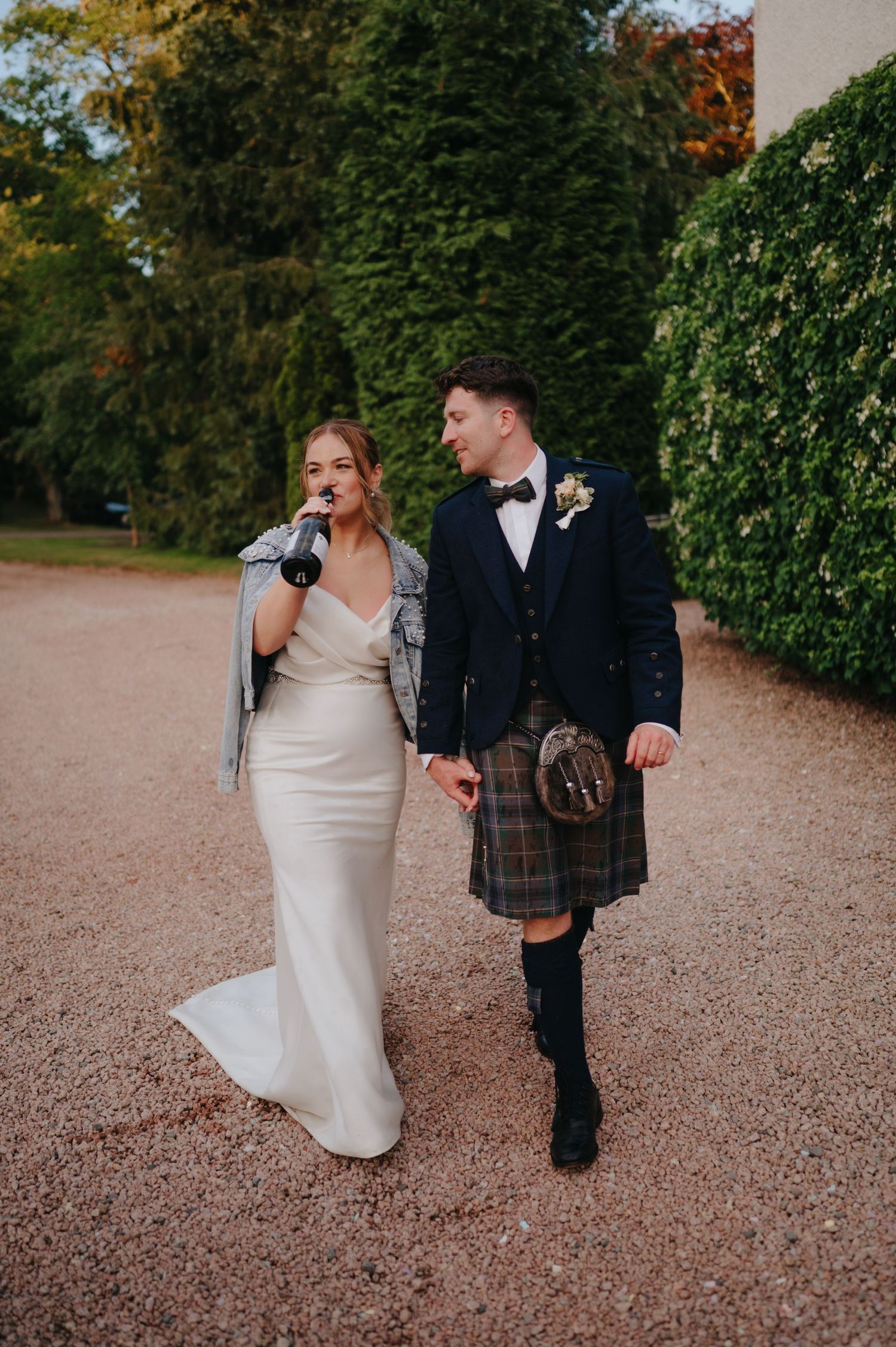 Bride and groom drinking champagne elsick house wedding