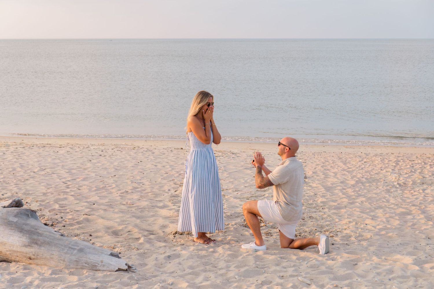 A series of beach photos showing tender moments between two people in white outfits on sandy shores at sunset.