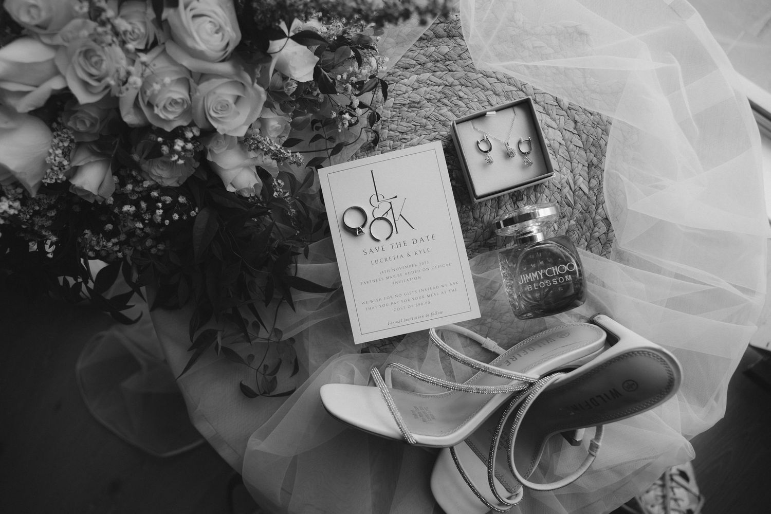 Black and white collage of wedding details including floral arrangements, invitations, and table settings at an elegant reception.