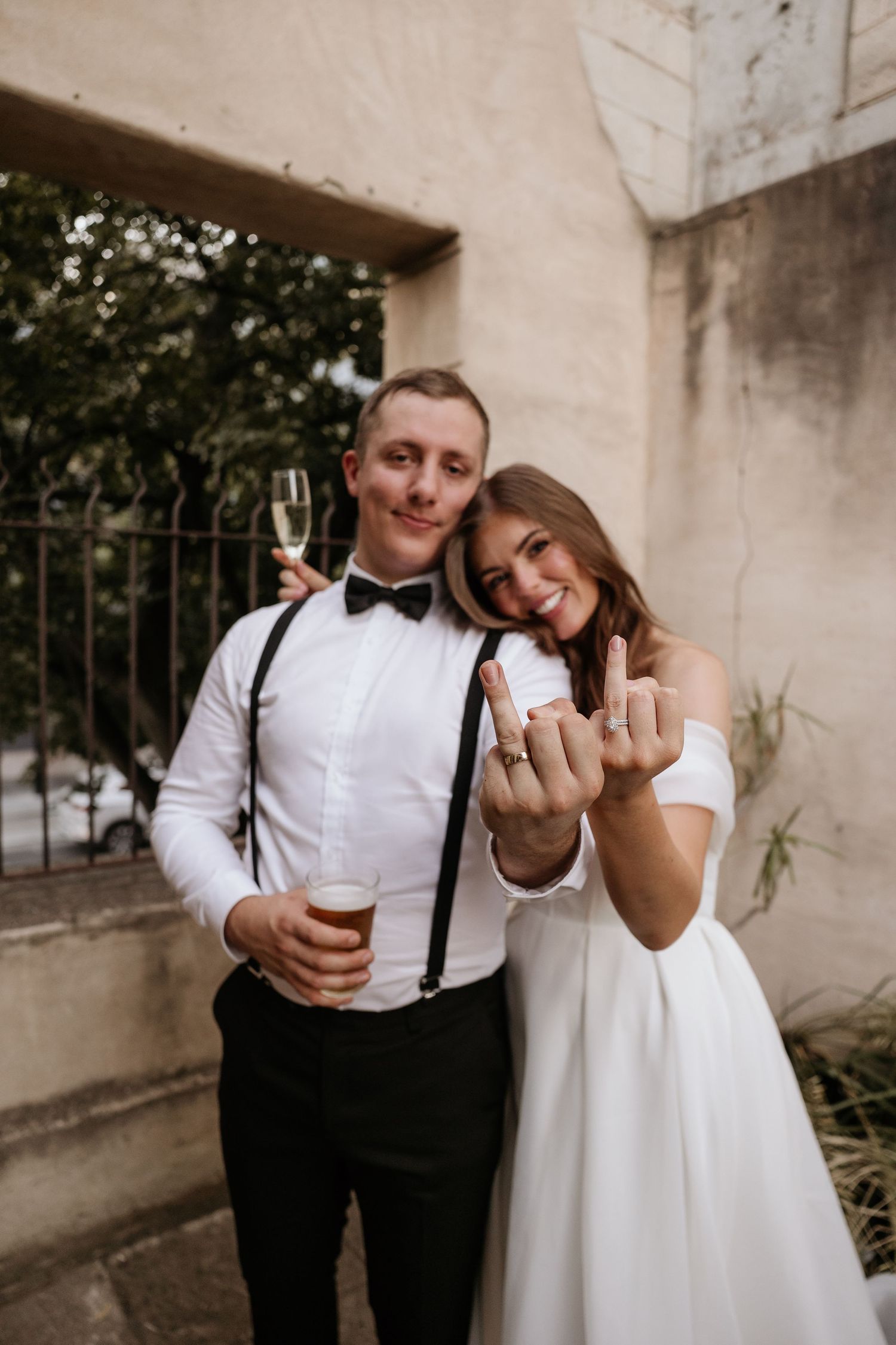 A couple in wedding attire shows off their rings and shares intimate moments in a series of candid photos.