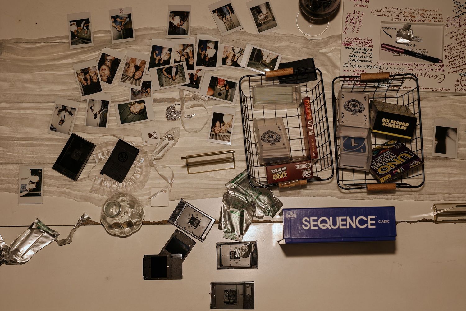 Collection of vintage photographs and memorabilia arranged in a sequence on a wooden surface.