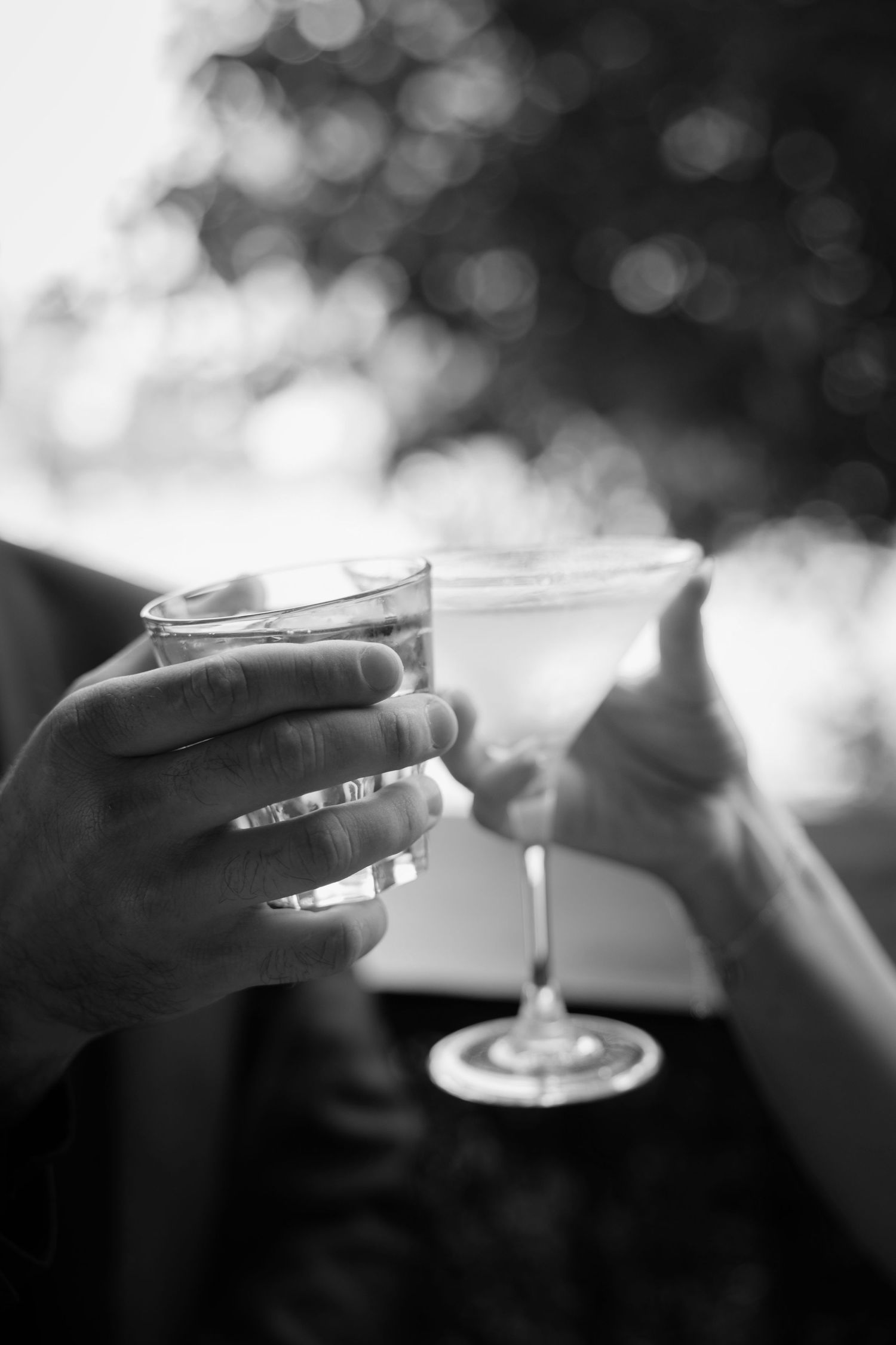 A black and white photo sequence showing hands holding a cigarette with smoke rising against a blurred background.