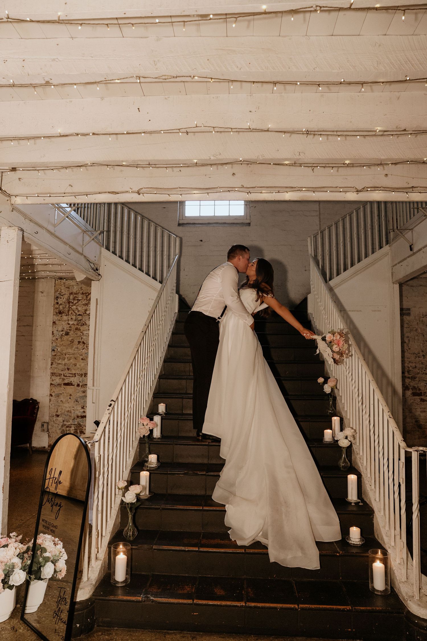 Romantic wedding photo sequence showing couple on vintage wooden staircase with white fabric draping and candles.