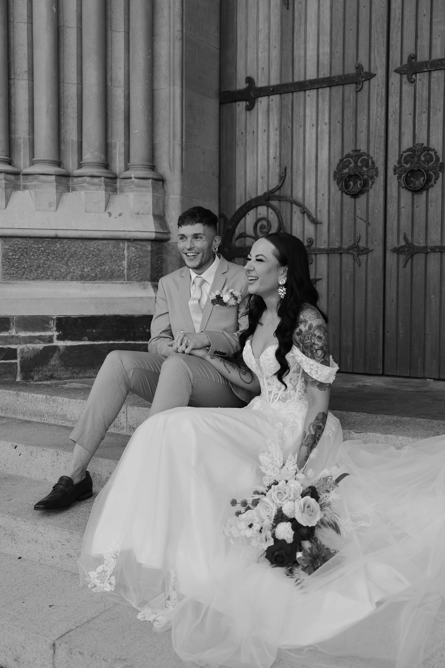 A series of black and white wedding photos showing a couple sitting and laughing together on stone steps.