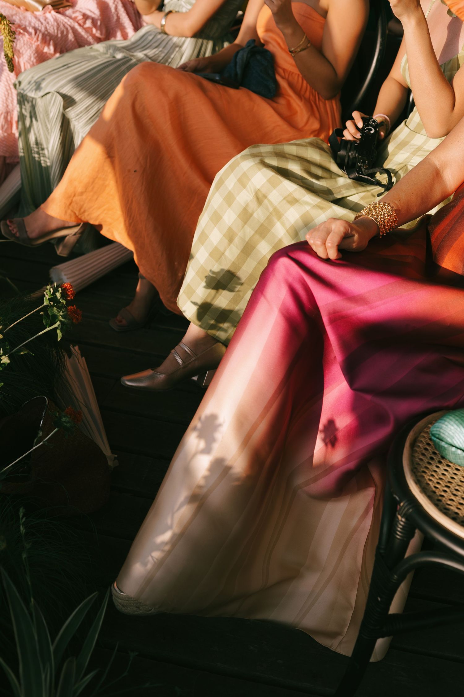 Abstract composition of formal attire and fabrics in warm tones and patterns.