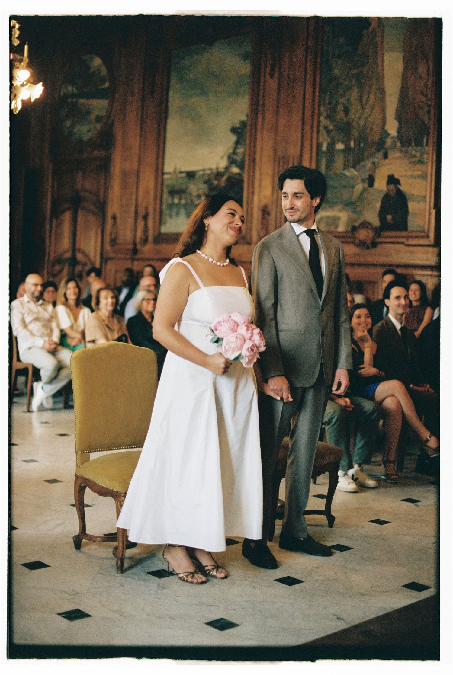 Wedding celebration in an elegant room with vintage decor and dancing.