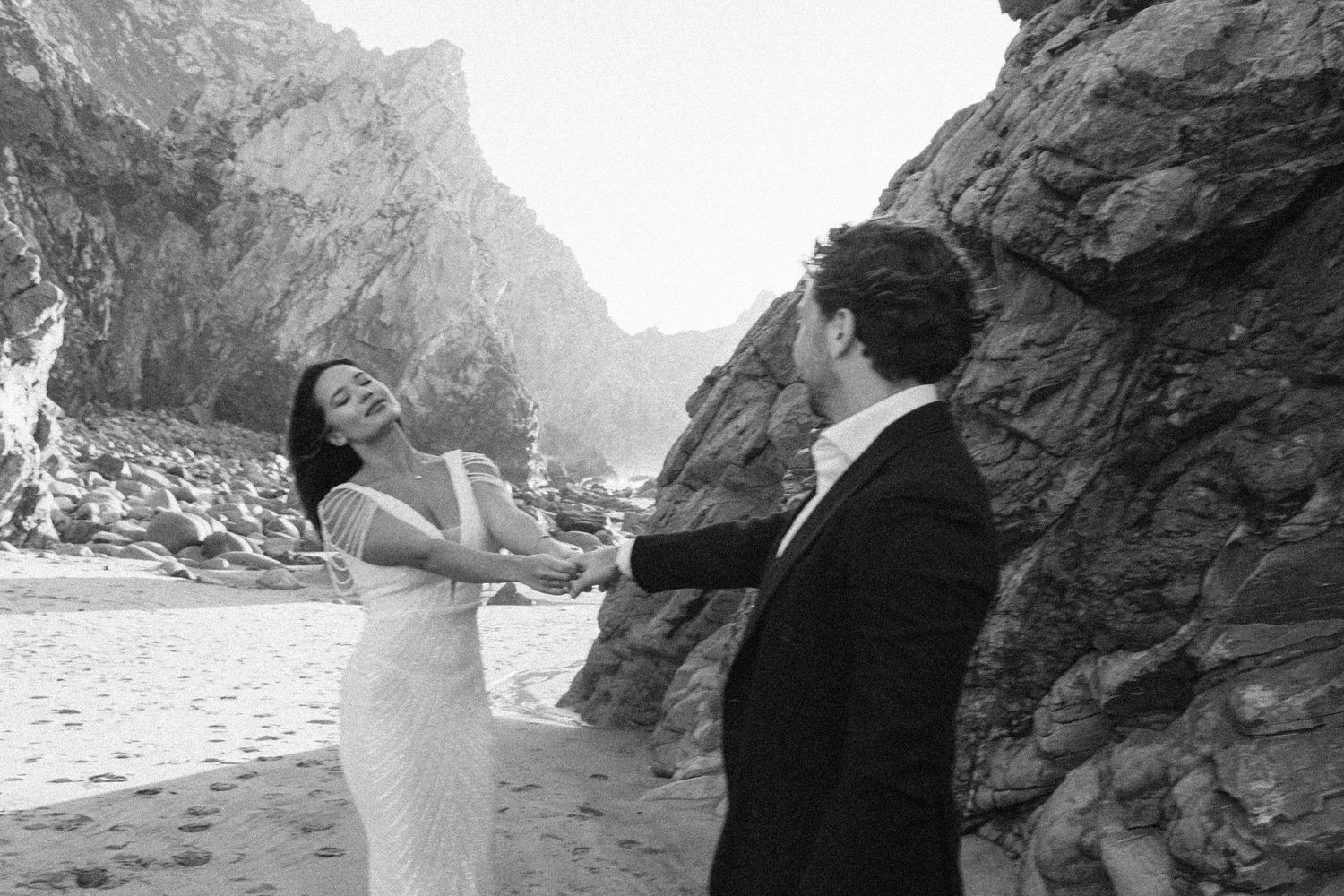Black and white photos of couples posing among dramatic coastal rock formations.