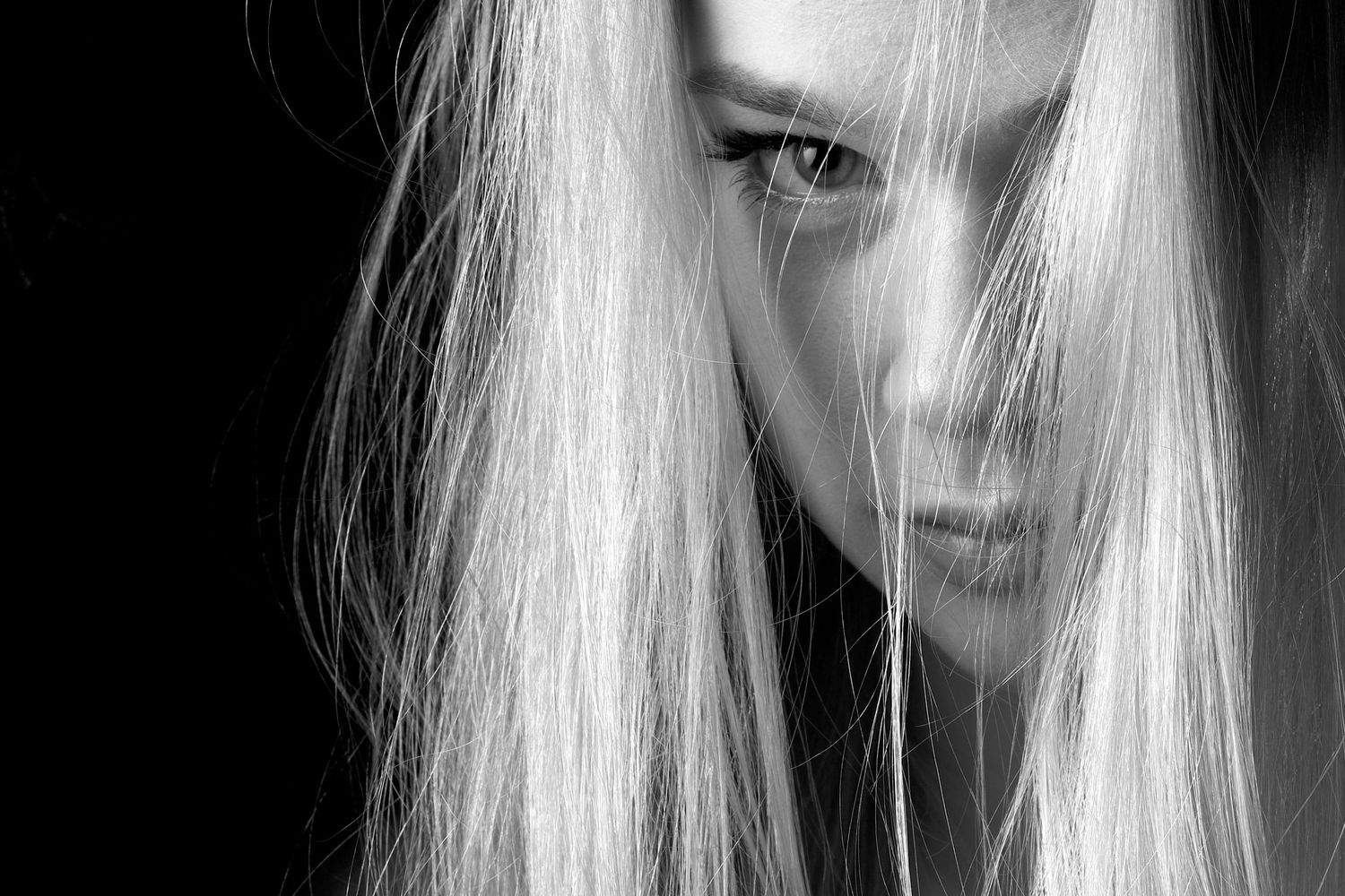 A series of black and white portrait photos showing close-up views of someone with long blonde hair.