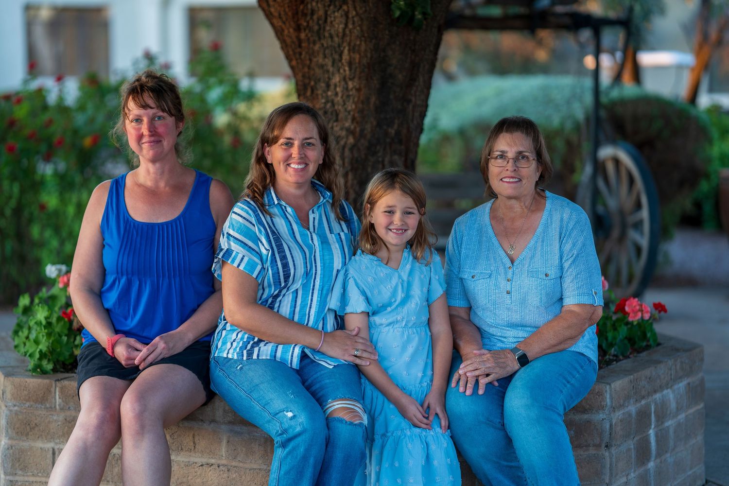 Candid outdoor family photo session with everyone wearing shades of blue.