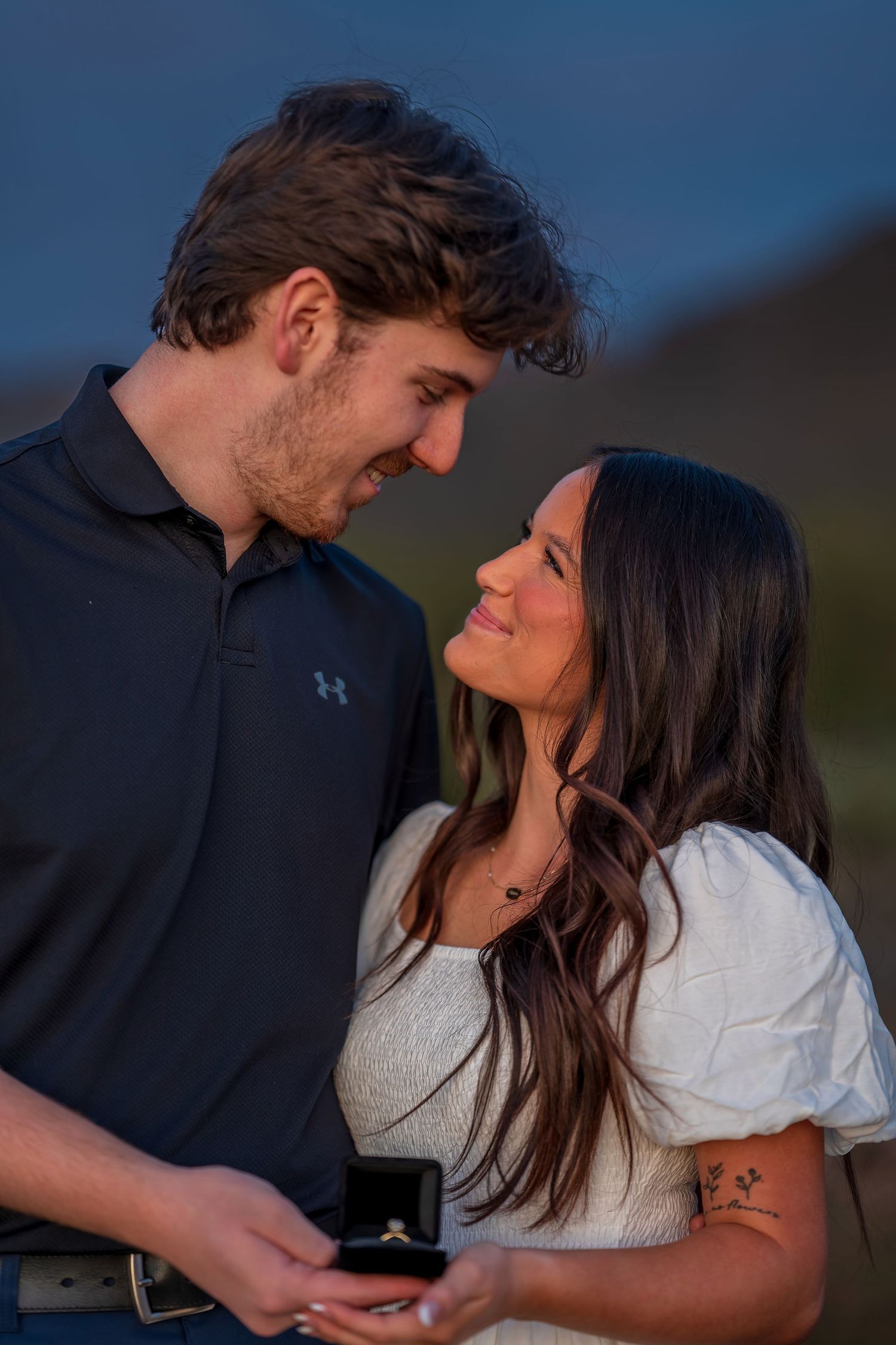 An intimate moment between a couple during their desert engagement photoshoot.