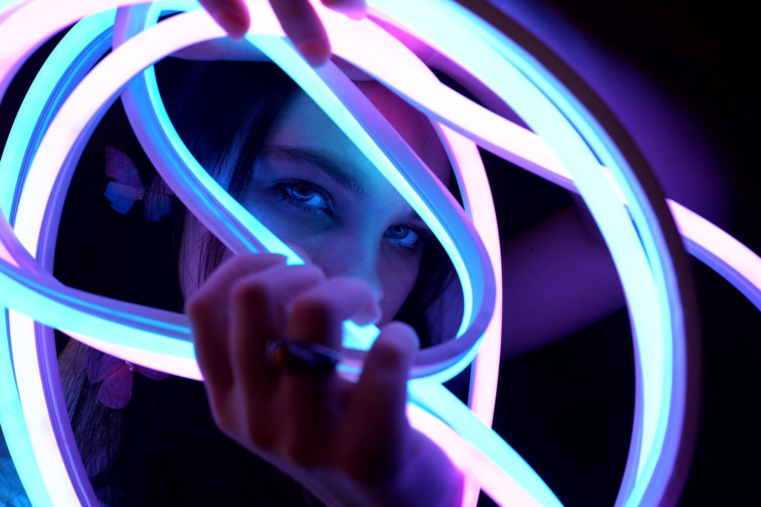 Abstract pattern of blue and purple neon lights glowing in darkness.