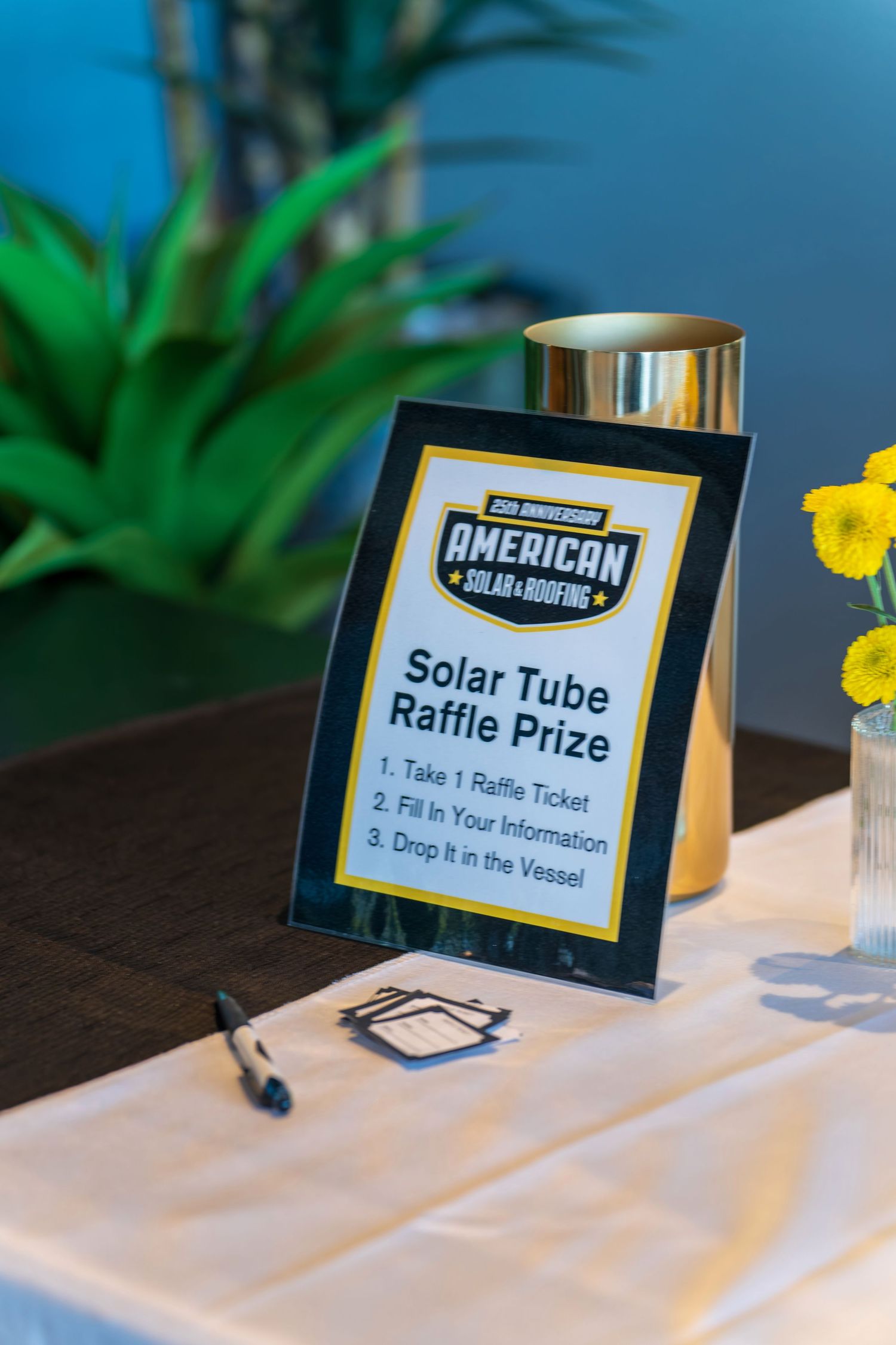 American Solar promotional display with raffle tickets and signage on white tablecloth.
