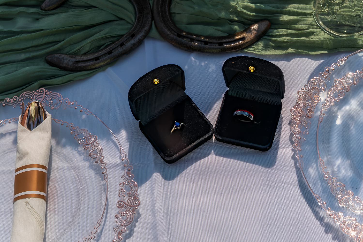 Row of formal suits and accessories laid out for a wedding party.