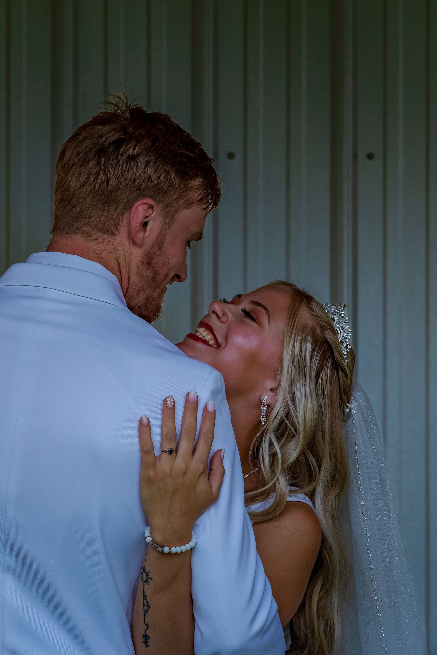 Artistic wedding photography sequence capturing romantic moments against an industrial backdrop.