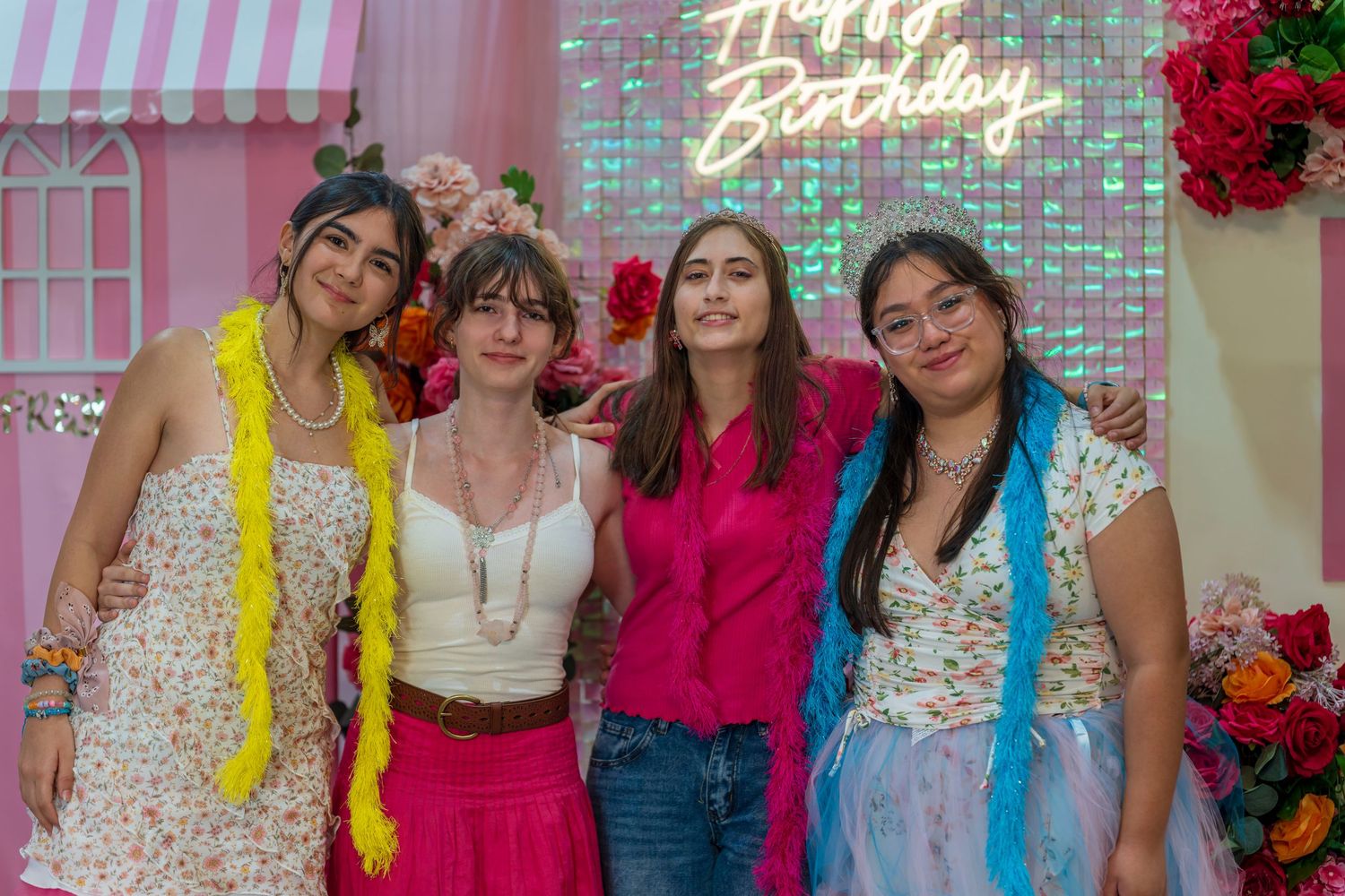 Pink-themed party space with neon signs and floral decorations.