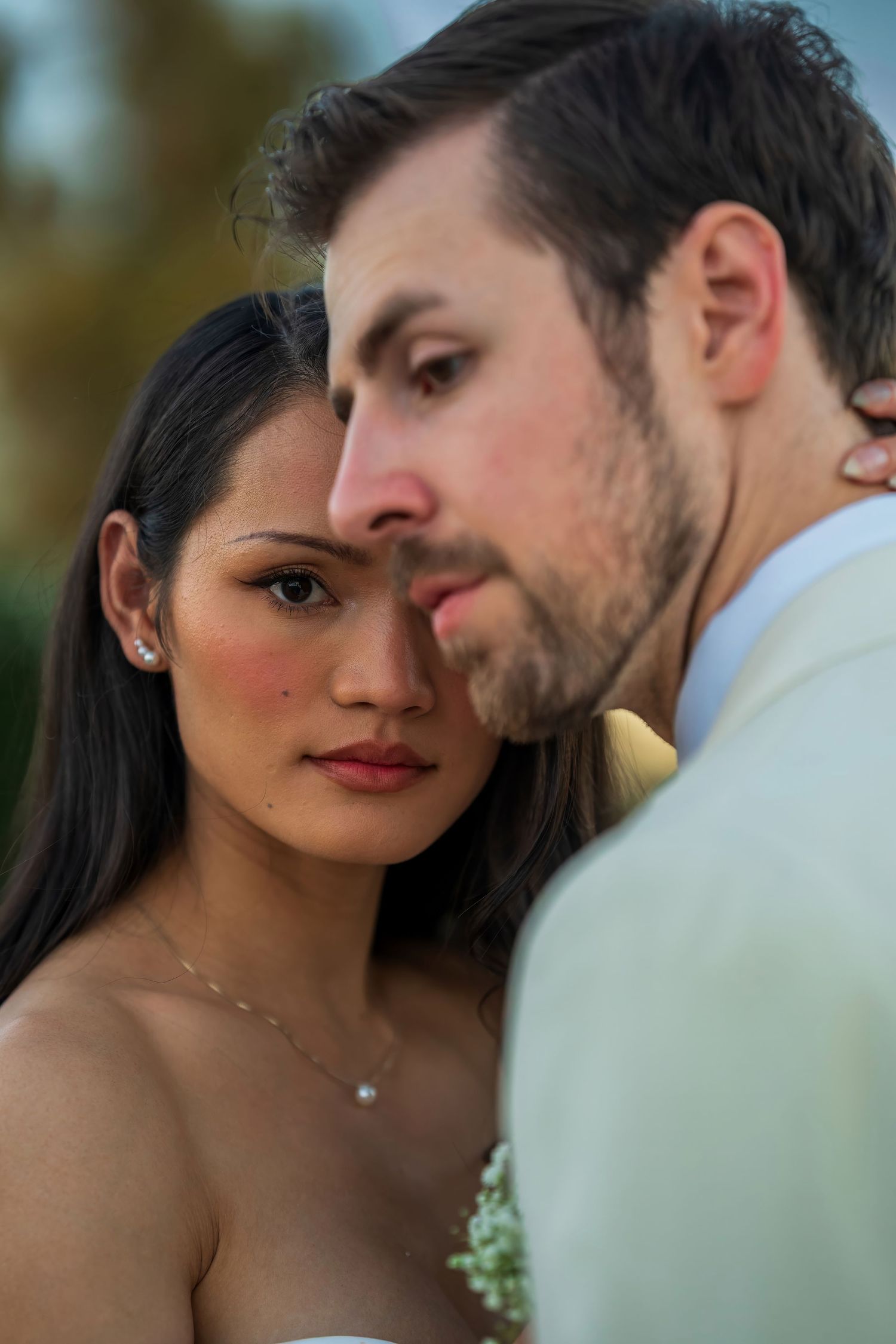 Close-up romantic wedding portrait with soft natural lighting.