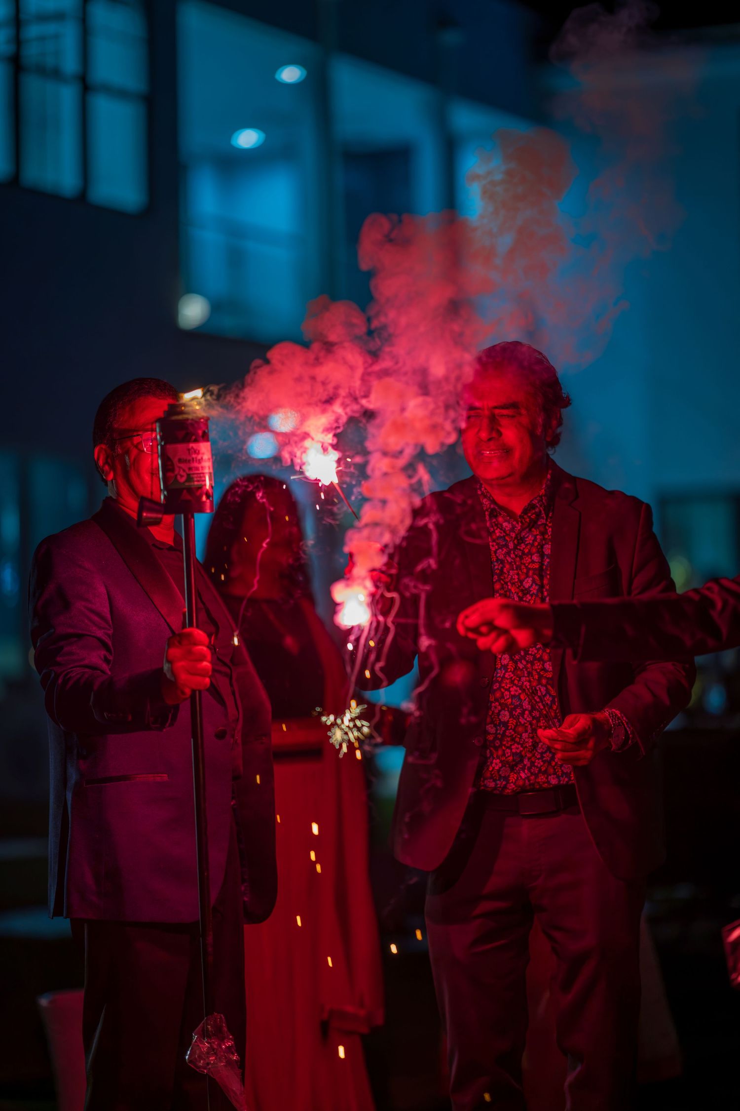 A group illuminated by red smoke and lights creates an atmospheric performance scene.