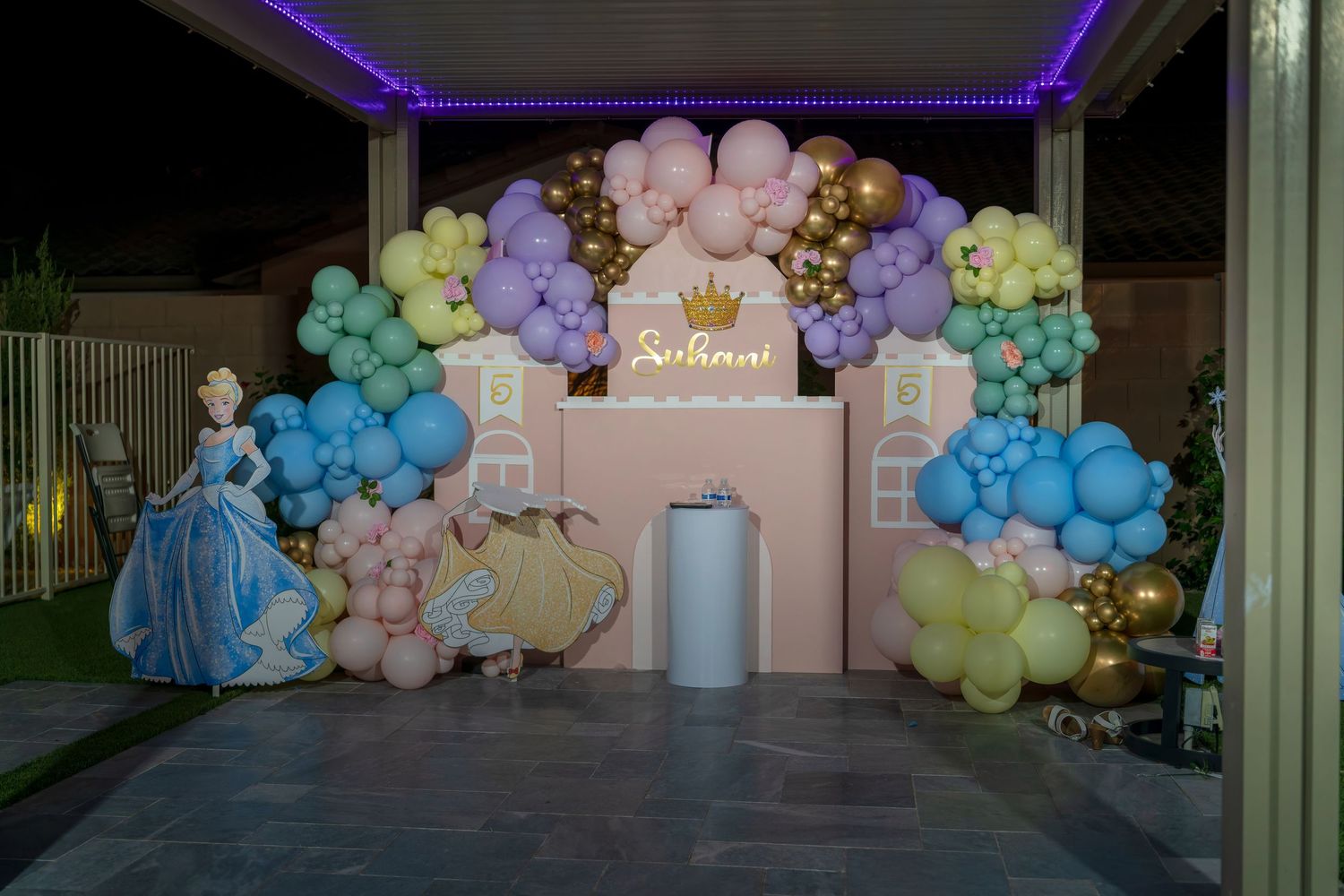 Pastel balloon arch installation with pink, blue, and yellow colors creating a festive backdrop.