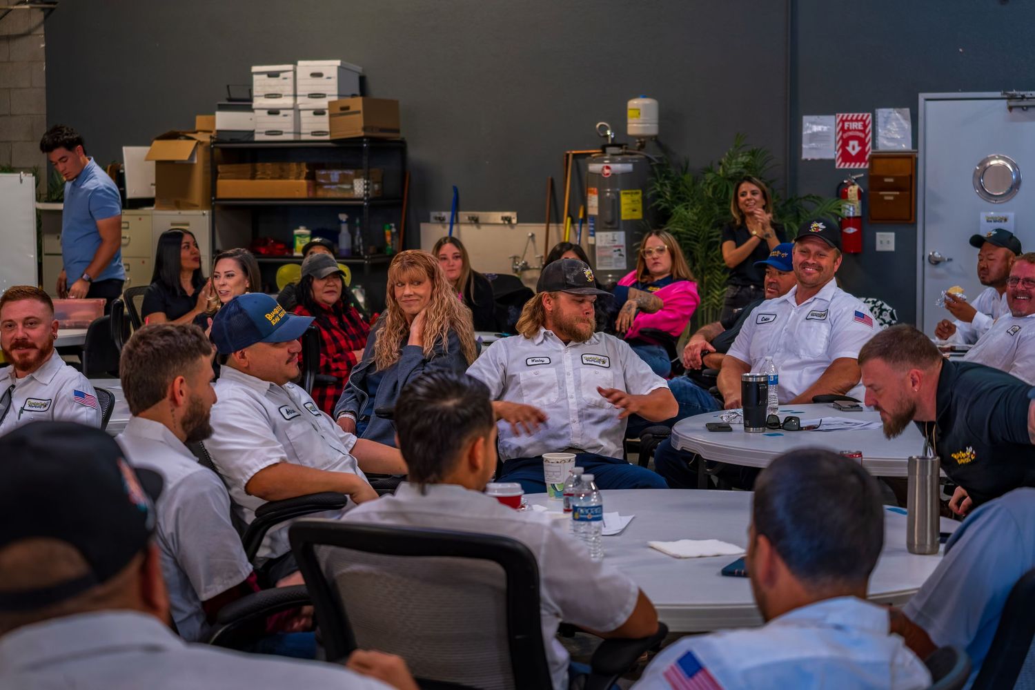 Group of employees gathered in a meeting room for a company presentation.