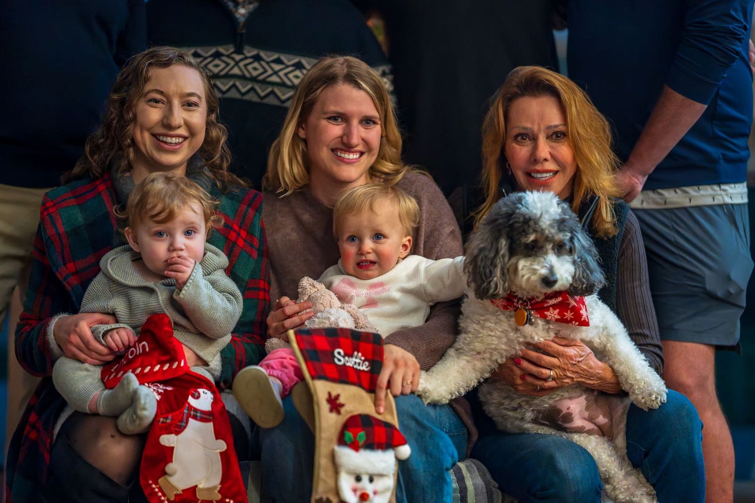 Family holiday portrait with Christmas stockings and decorations.
