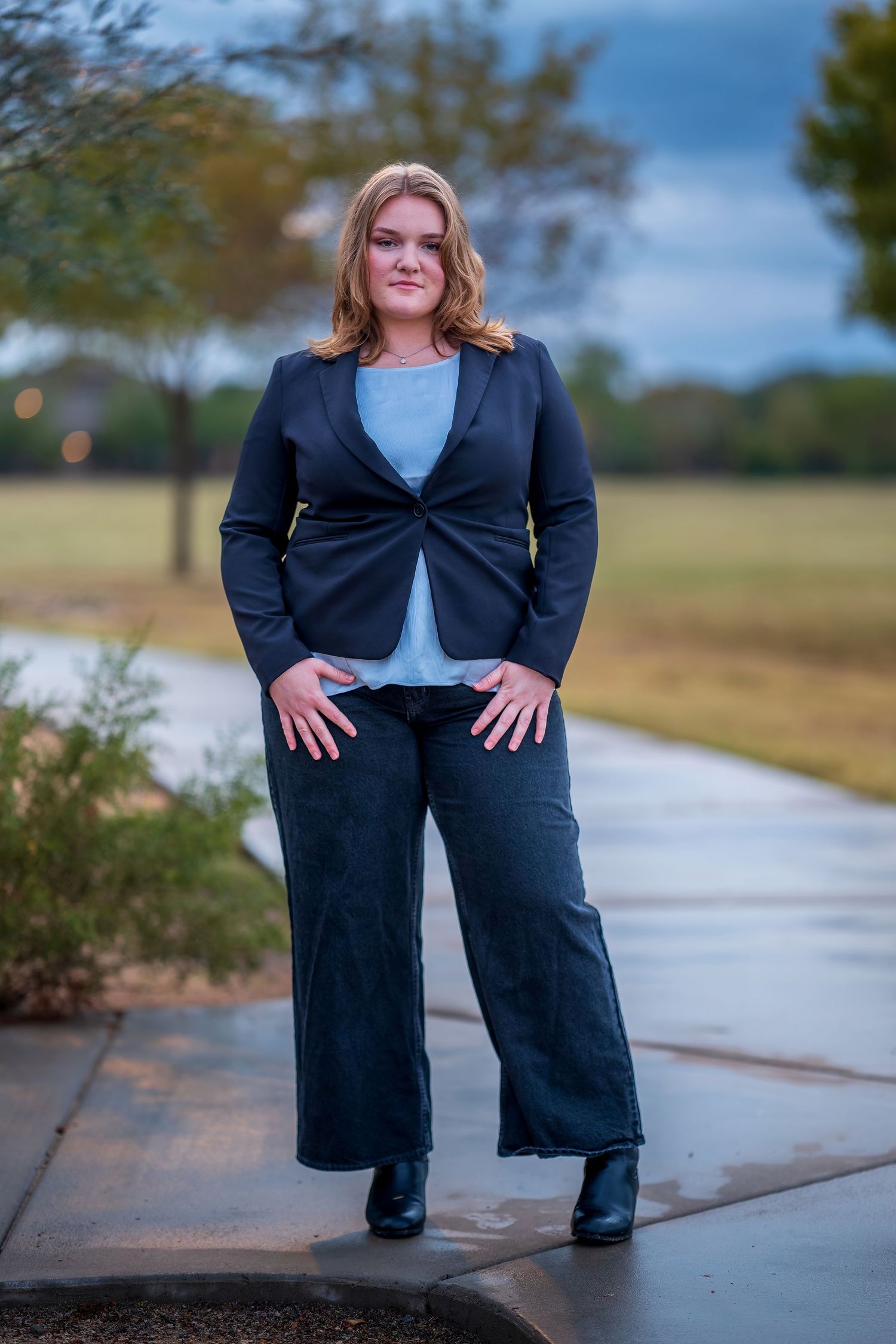 Professional portrait session showing business attire and casual poses on an outdoor pathway.