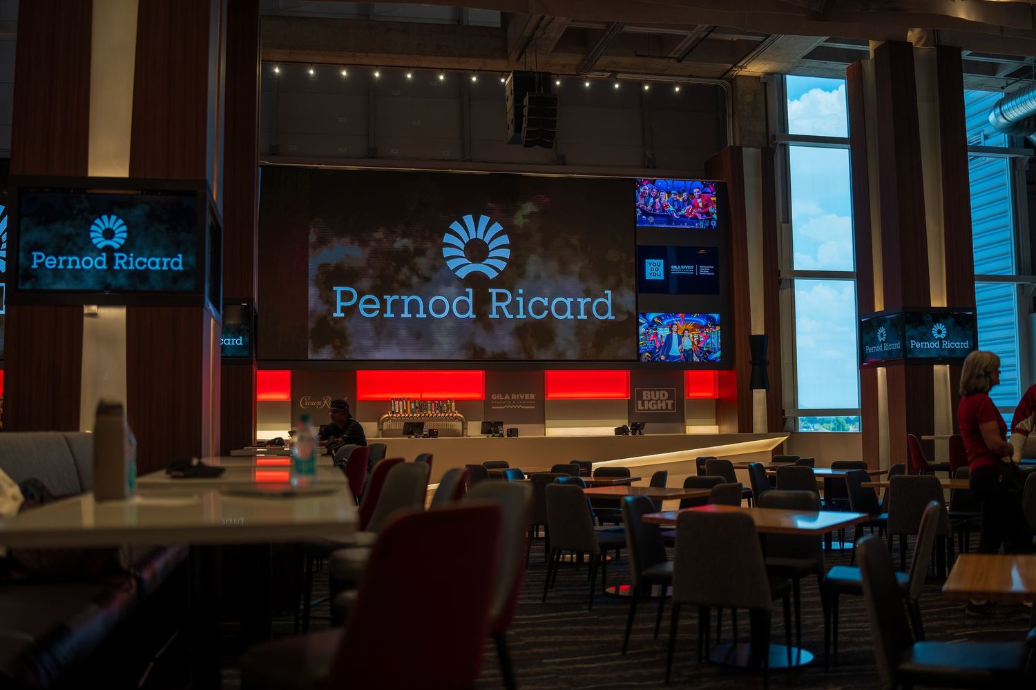 Modern bar space with dimly lit atmosphere and branded displays.