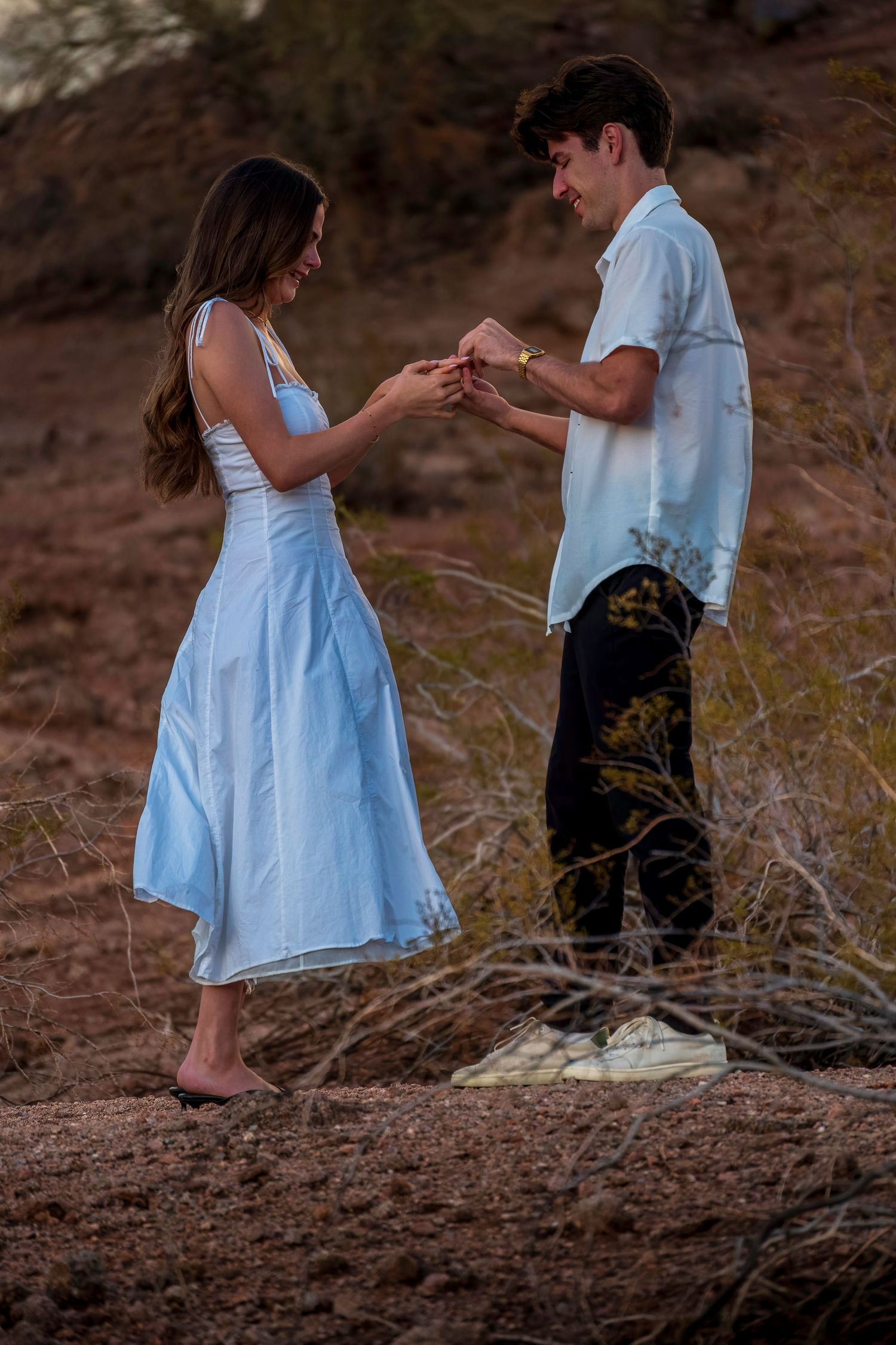 Proposal sequence captured on rocky terrain at dusk.