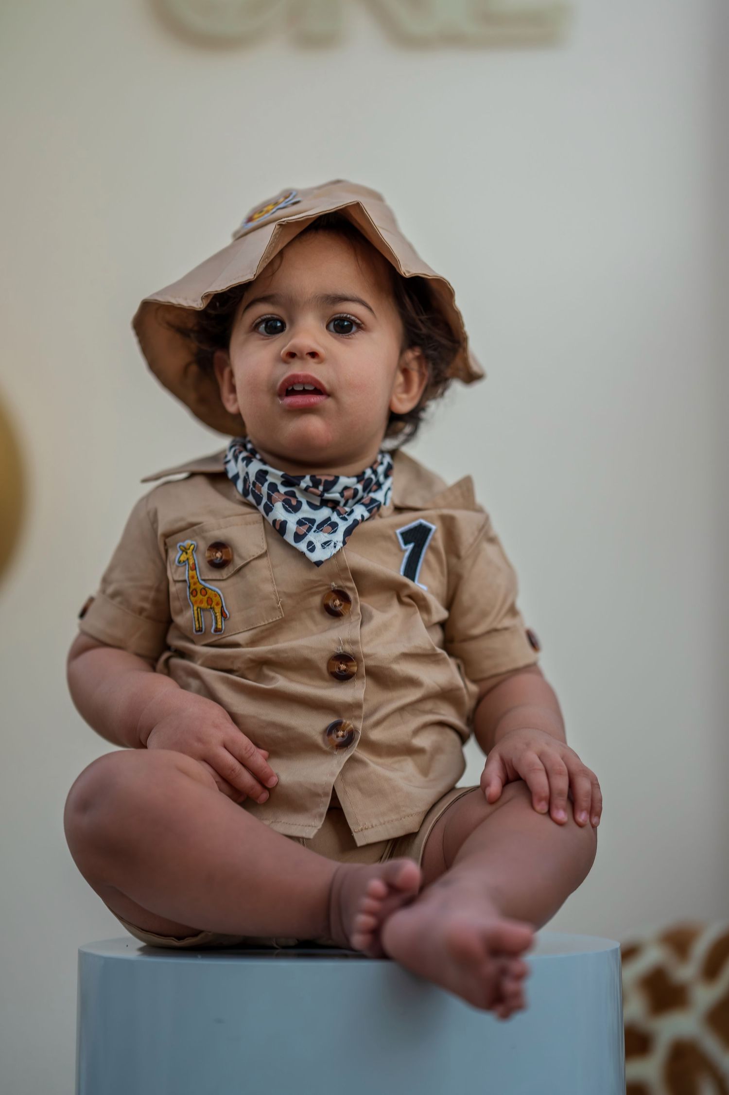 First birthday party setup with safari decorations and a special seating arrangement.