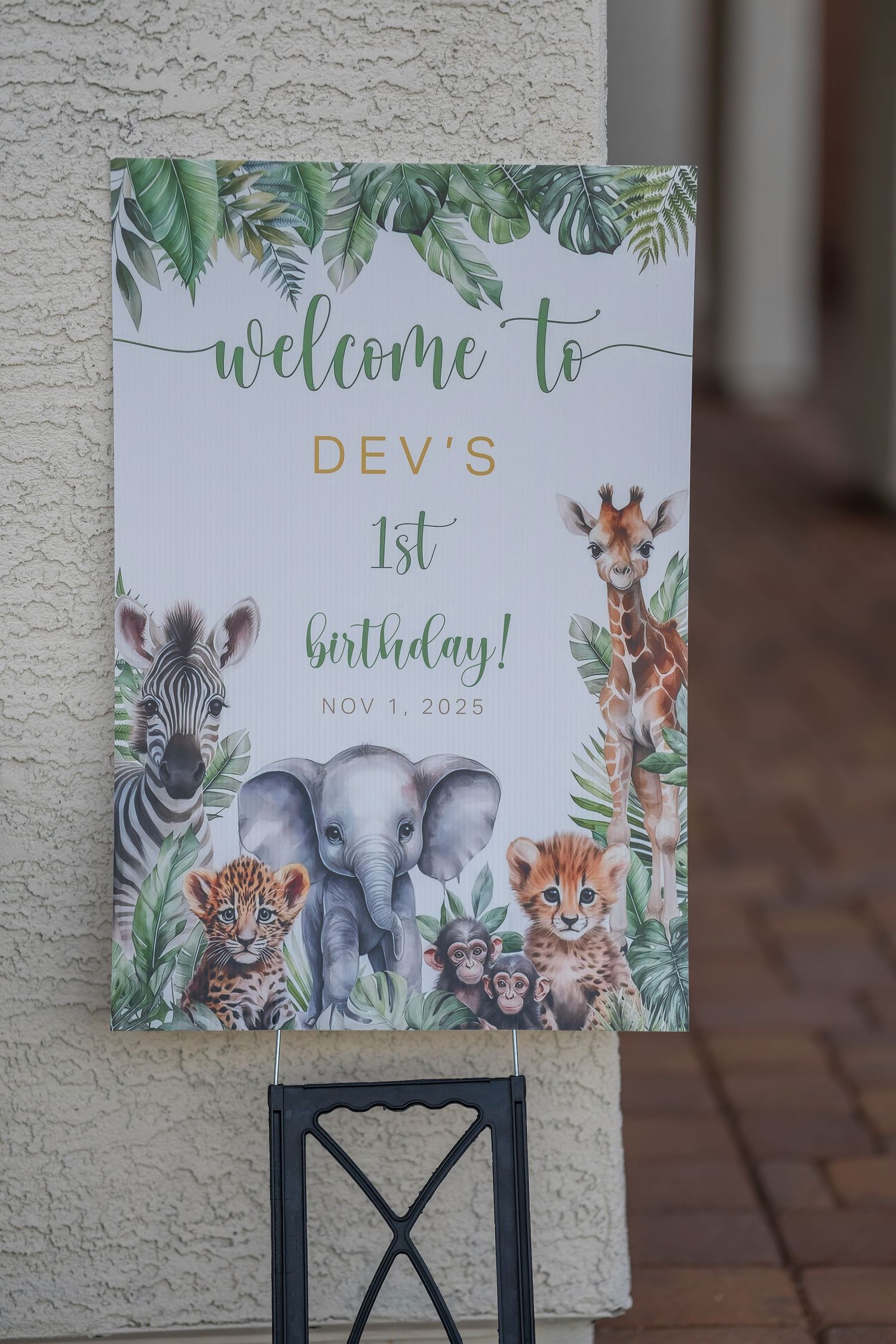 Safari themed birthday party decorations featuring cartoon elephants, zebras, and jungle animals.