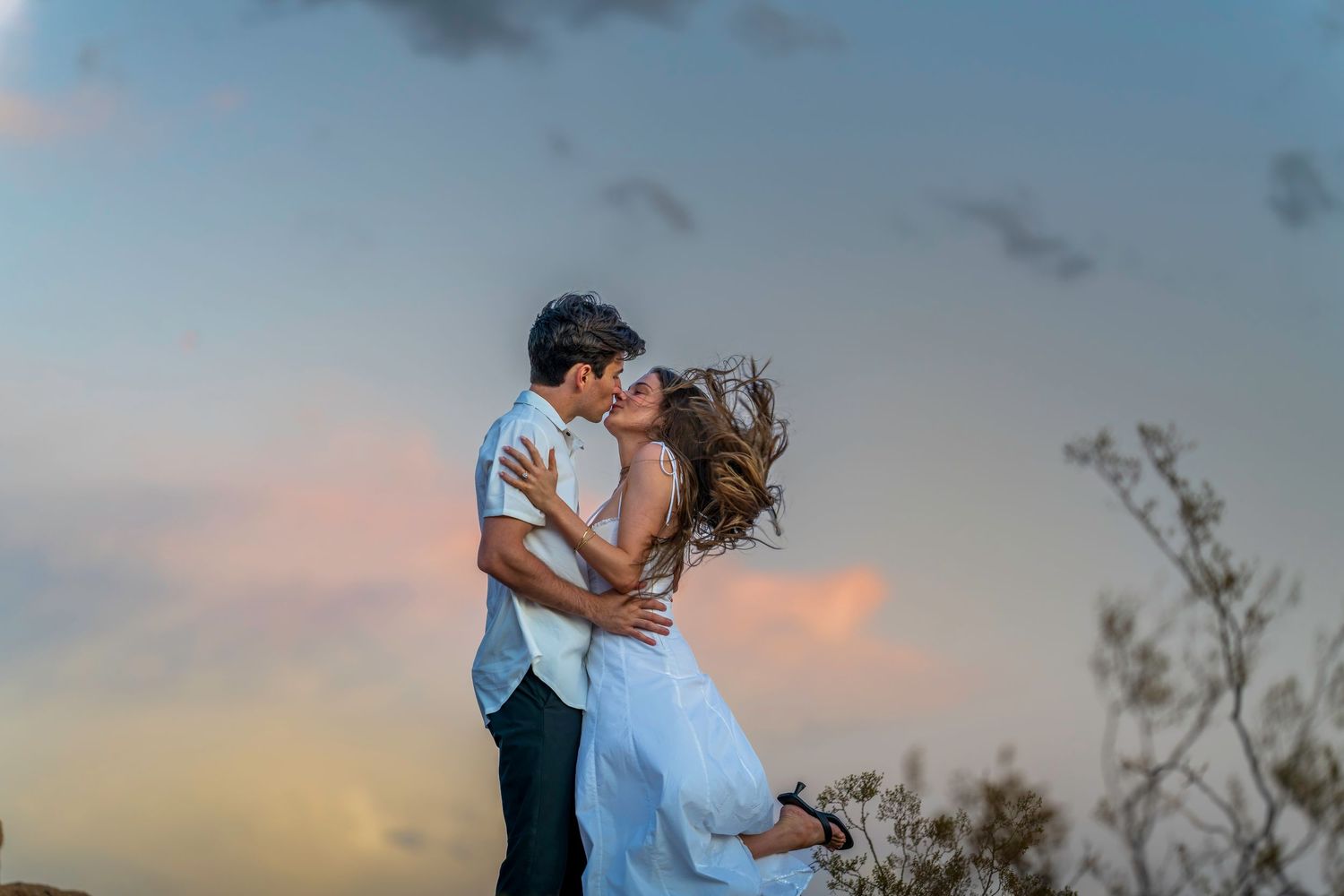 A couple in motion captures a romantic moment during golden hour.