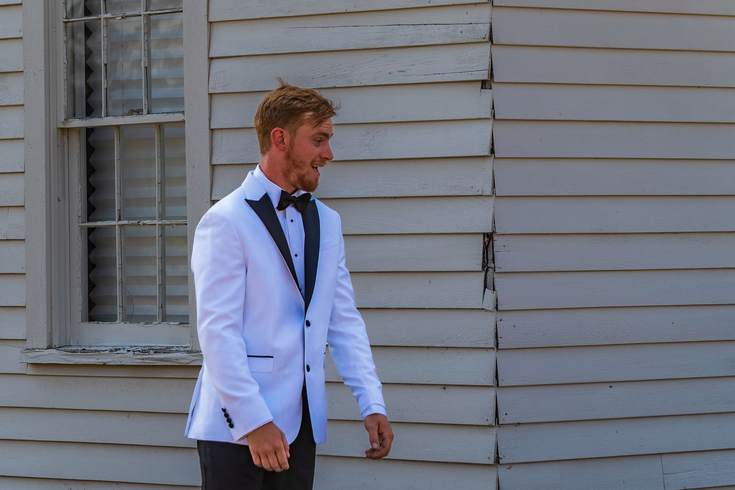 Intimate wedding moment shared between couple in white attire.
