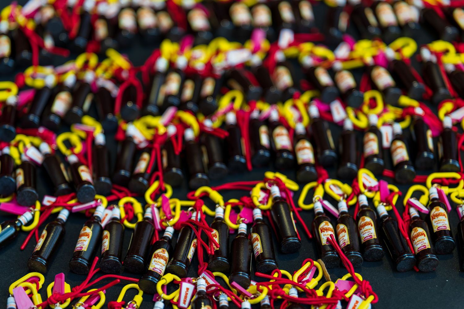 Close-up of red and yellow graduation tassels arranged in repeating pattern.