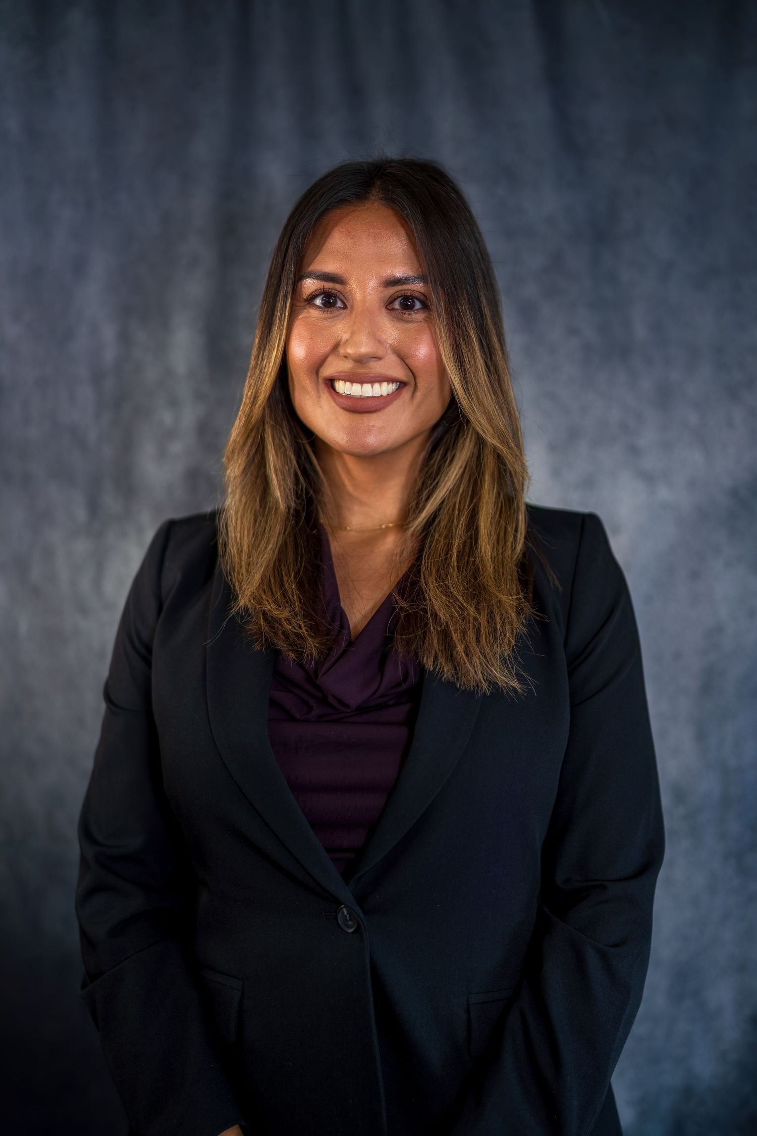 Corporate portrait series in dark blazer showing professional poses.