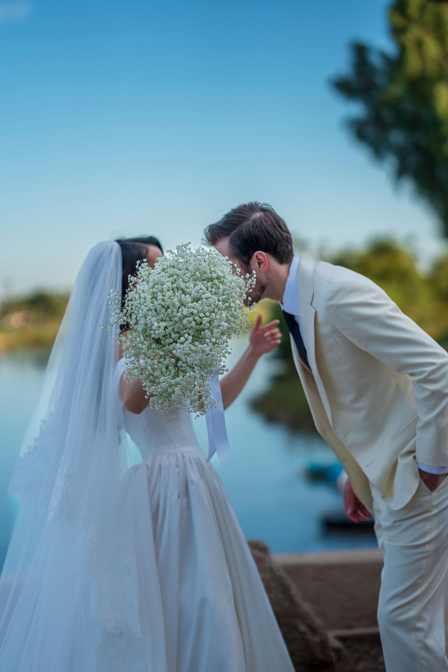 A romantic wedding photo sequence with baby's breath flowers creating a playful moment.