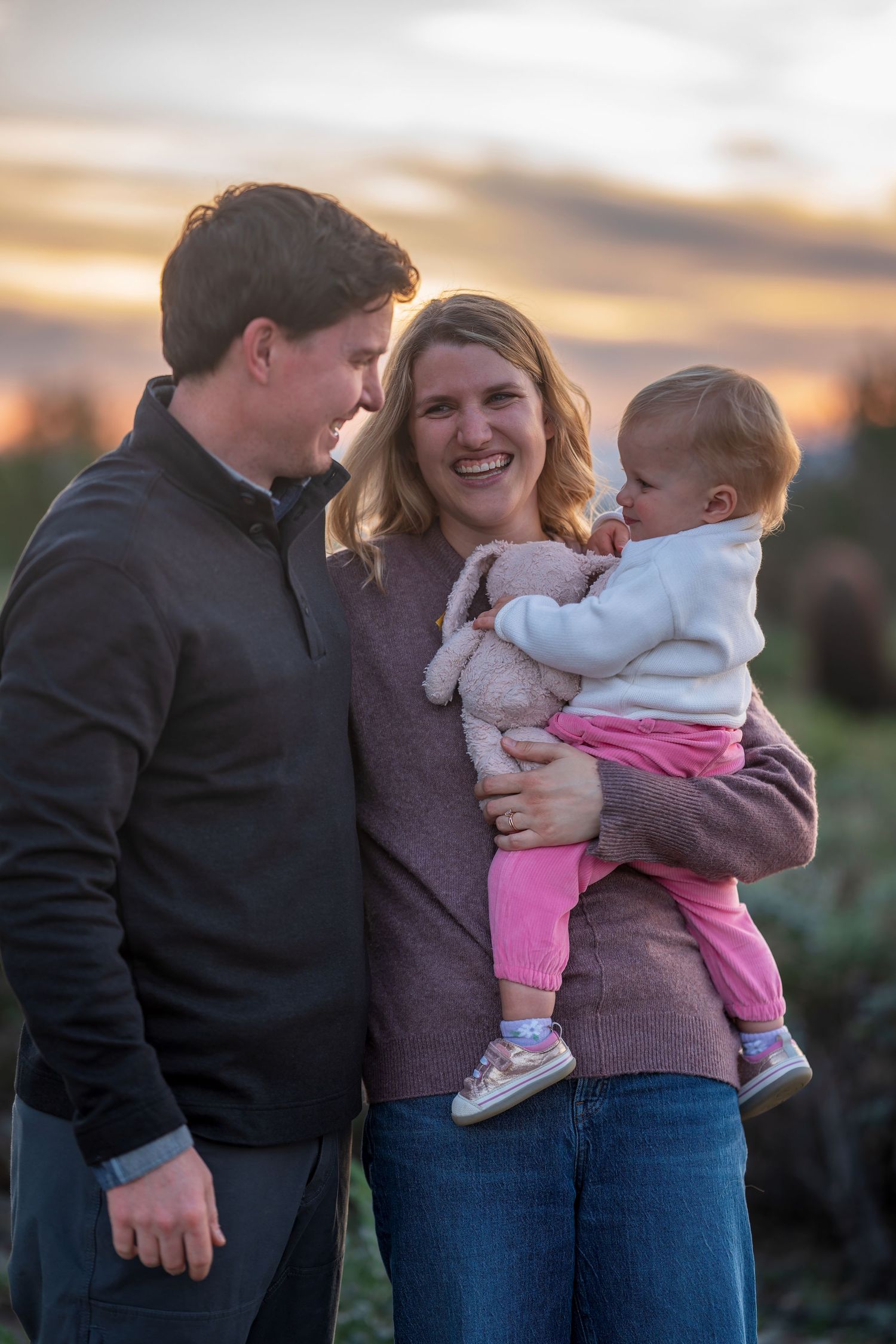 Series of casual family portraits showing tender moments at sunset.