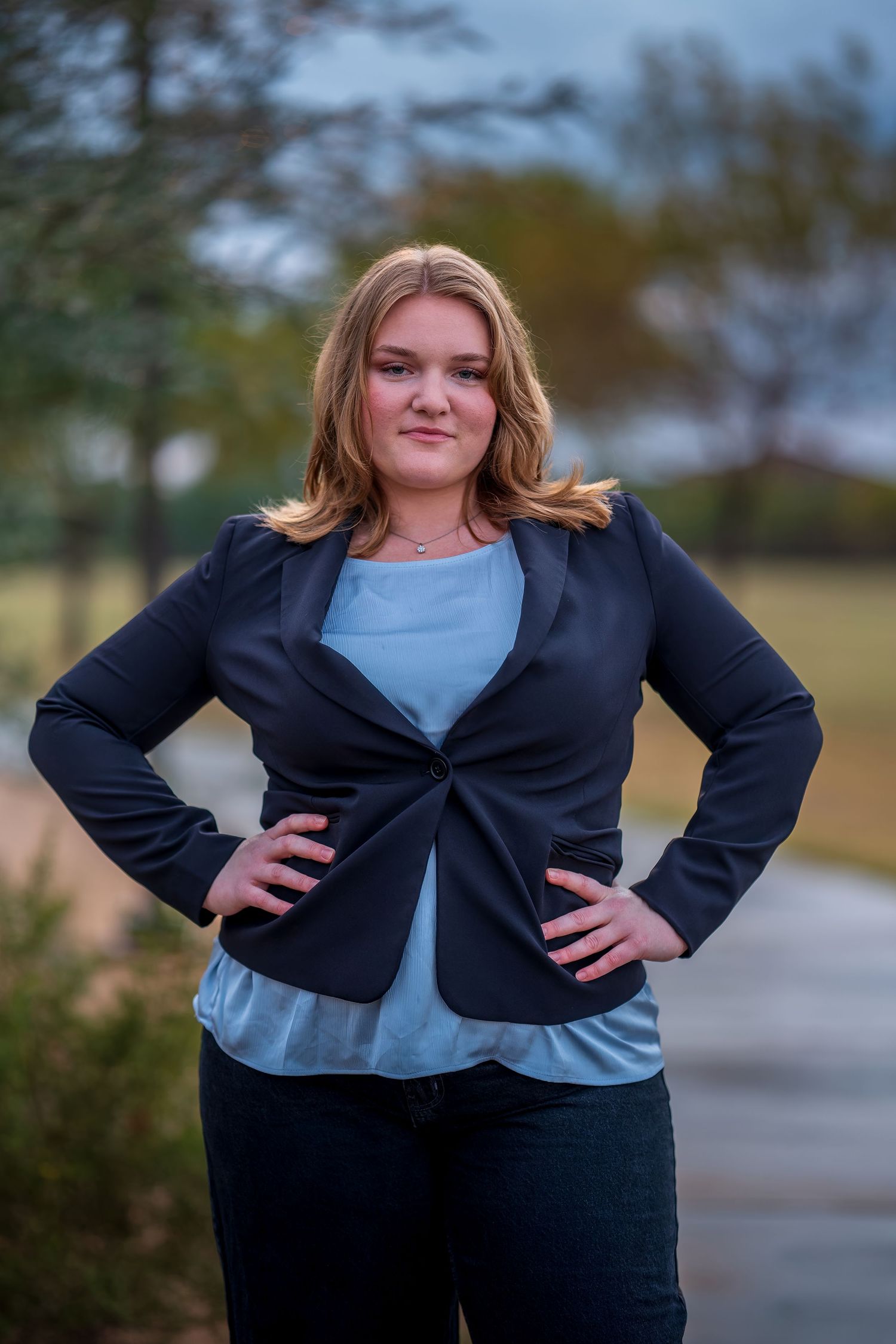 Professional outdoor photoshoot featuring navy business attire and casual poses.