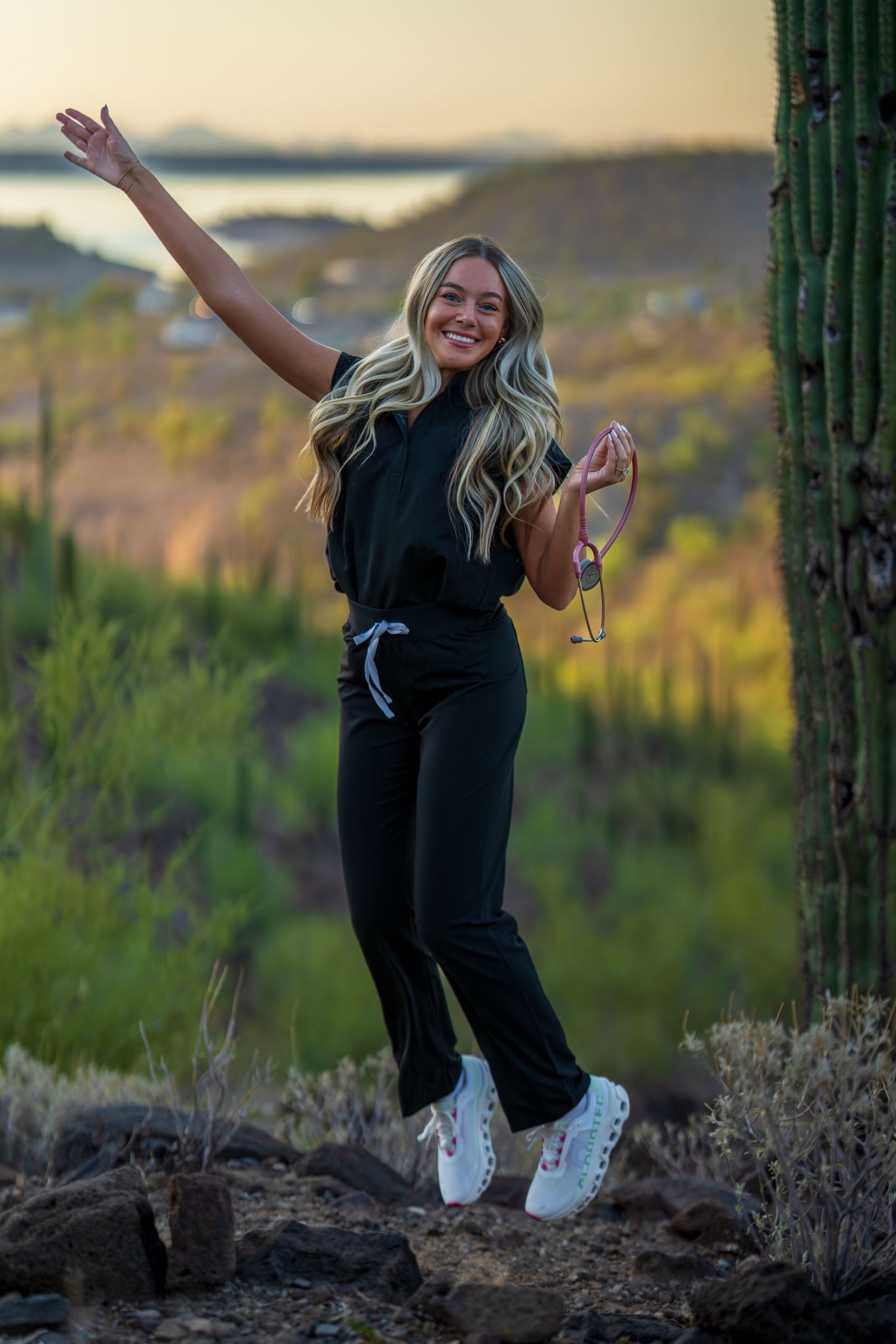 Joyful medical professional strikes dynamic poses among desert cacti at golden hour.