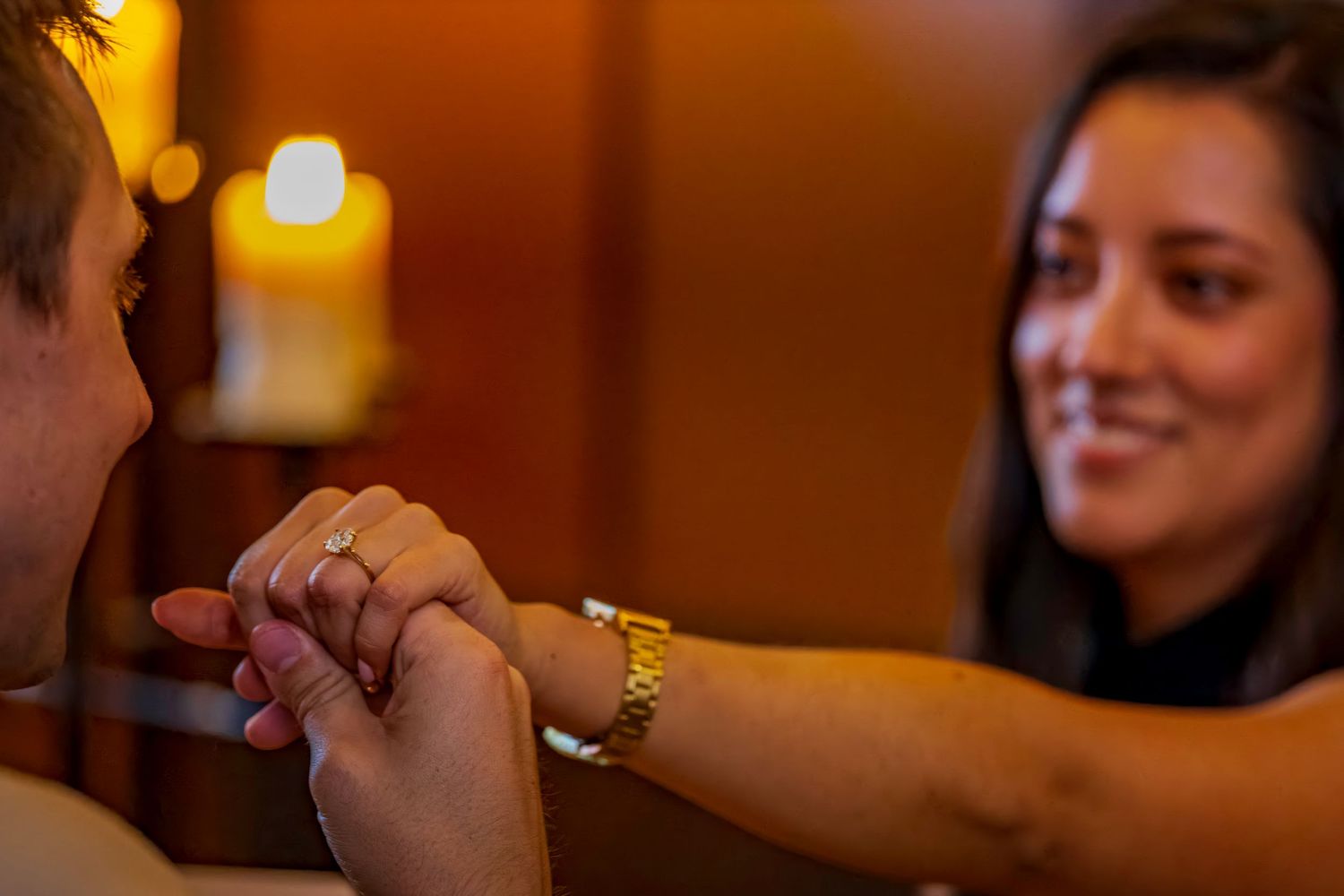 People celebrating with champagne in an intimate restaurant atmosphere.