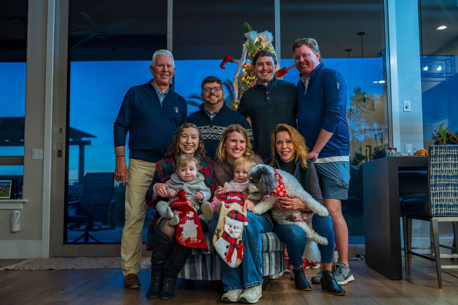 A holiday gathering with a decorated Christmas tree in the background.