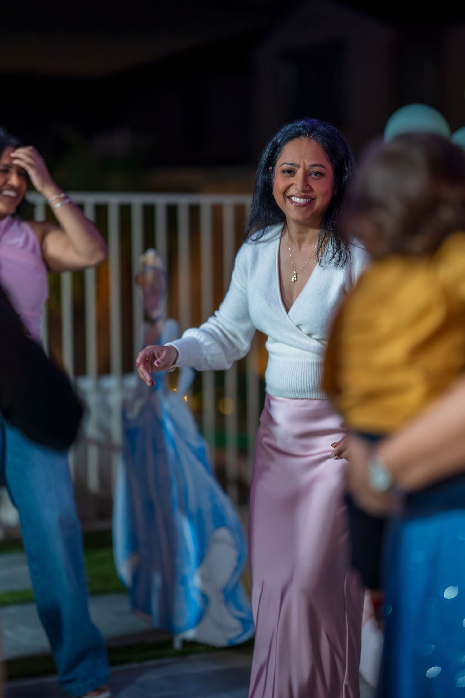 People enjoying a lively celebration outdoors with festive decorations.