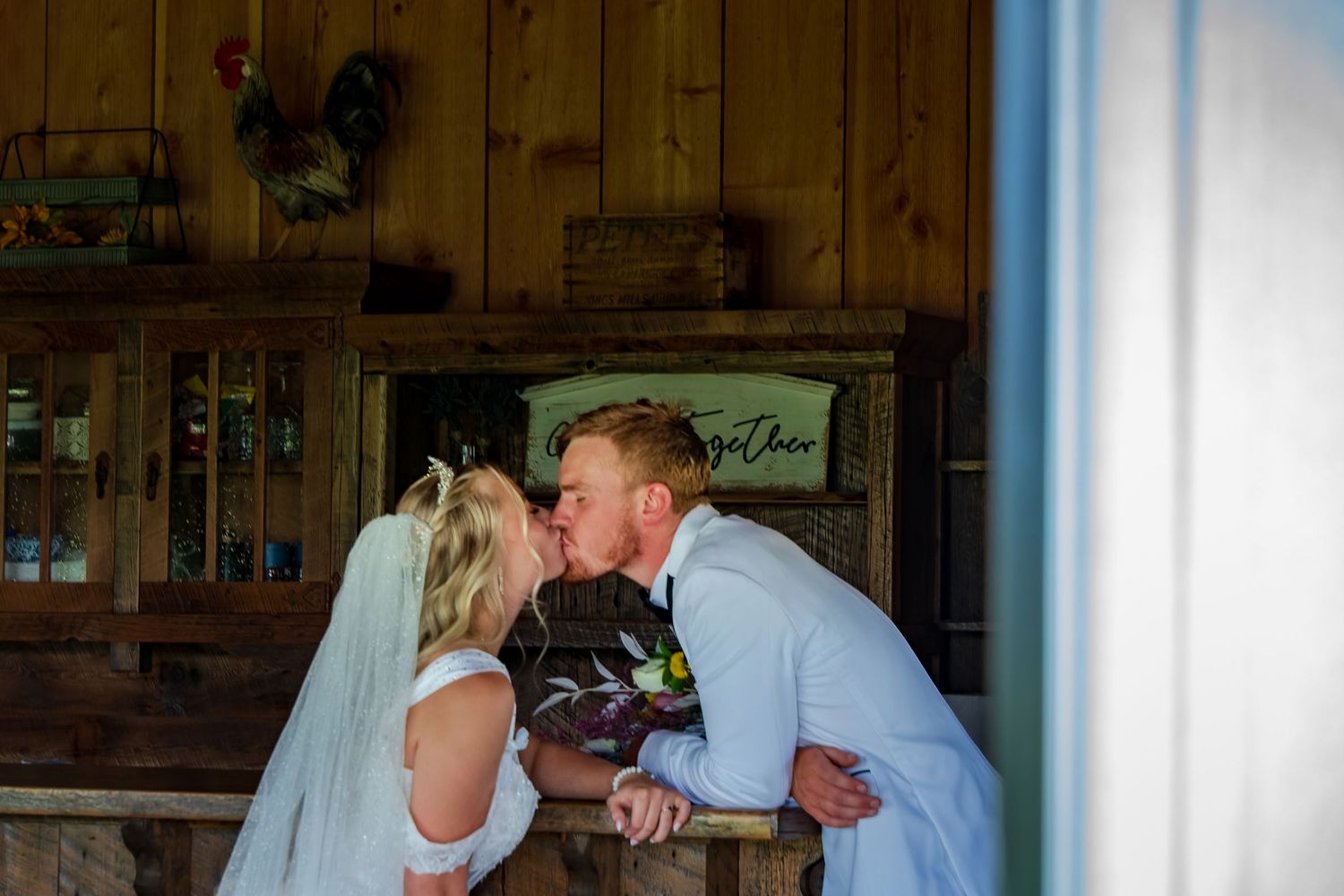 Wedding dance captured in rustic venue with wooden paneled walls.