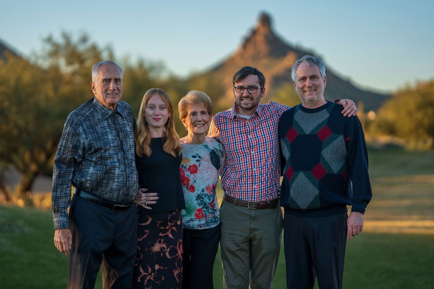 Casual outdoor family photos with desert mountain scenery in warm evening light.