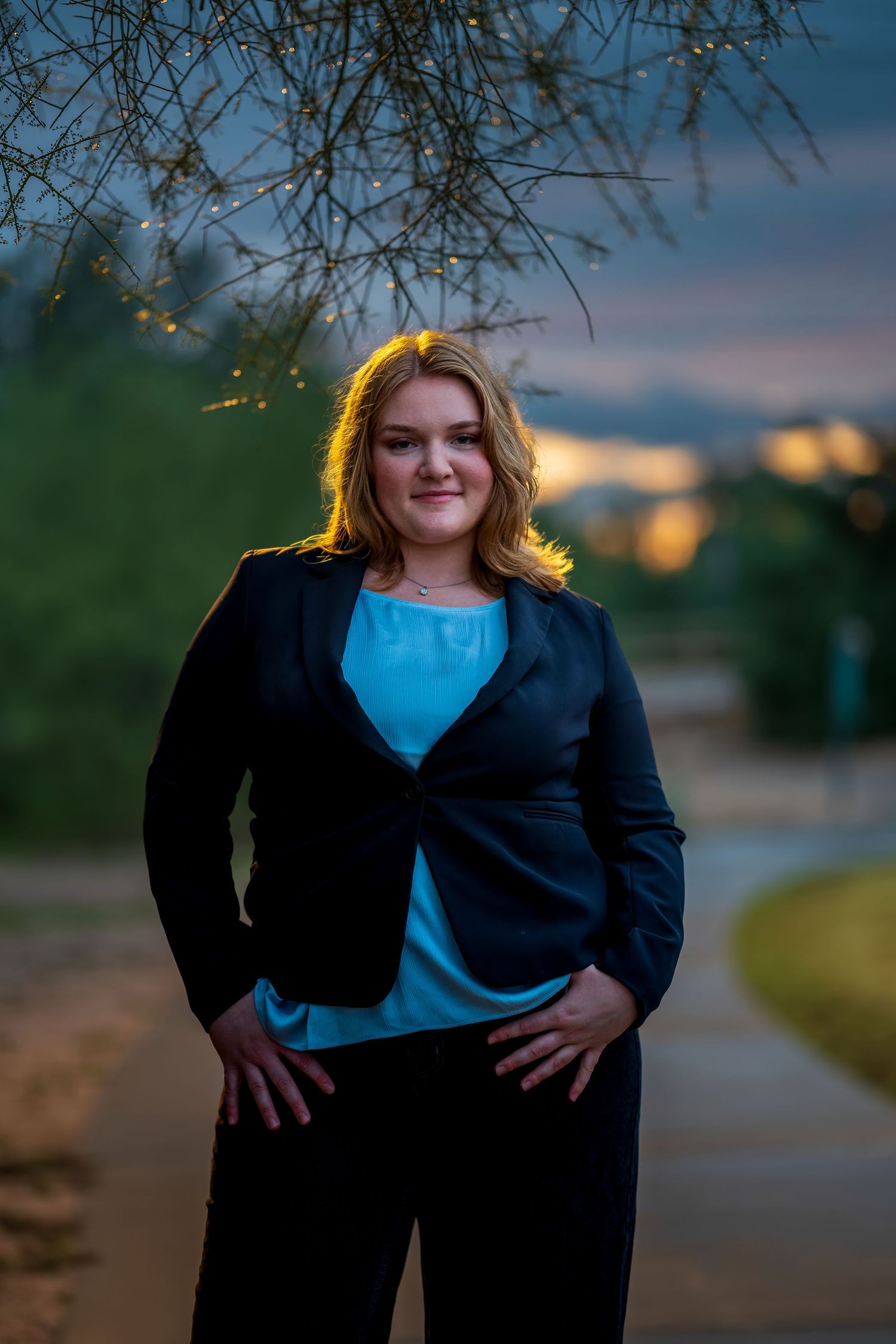 Golden hour portrait with tree branches framing the scene.