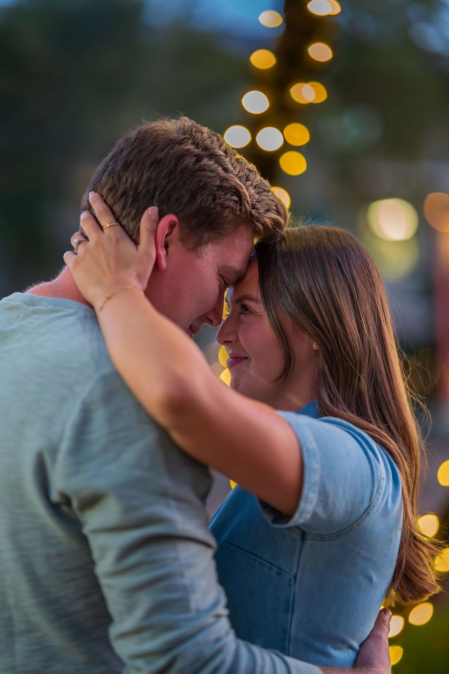 A romantic evening portrait with bokeh lights creating a dreamy atmosphere.