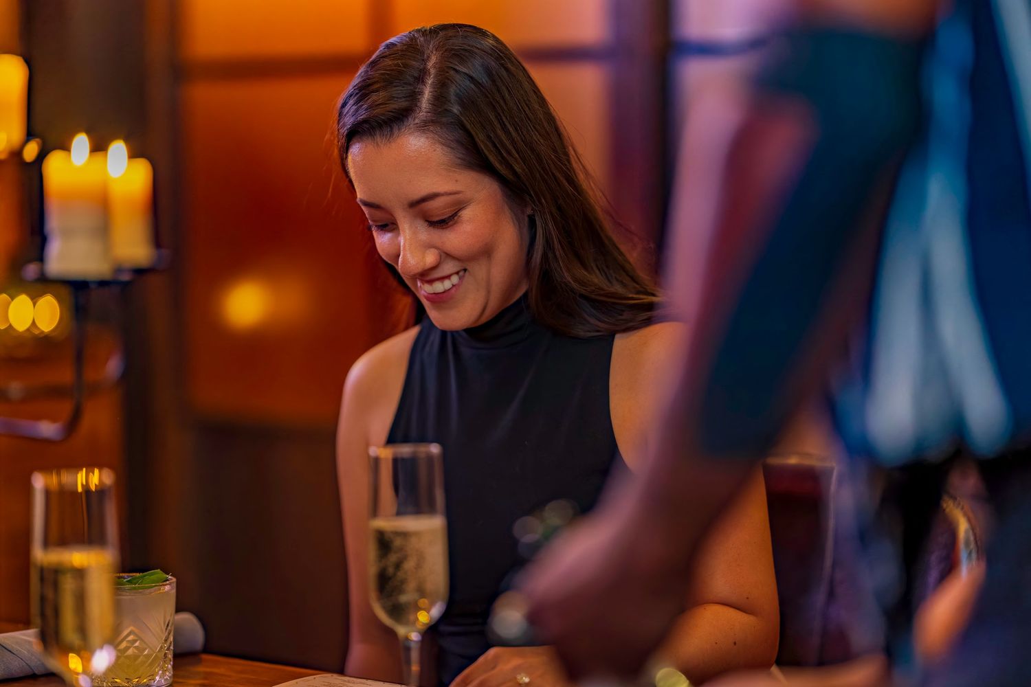 Romantic dinner setting with warm candlelight and champagne glasses.