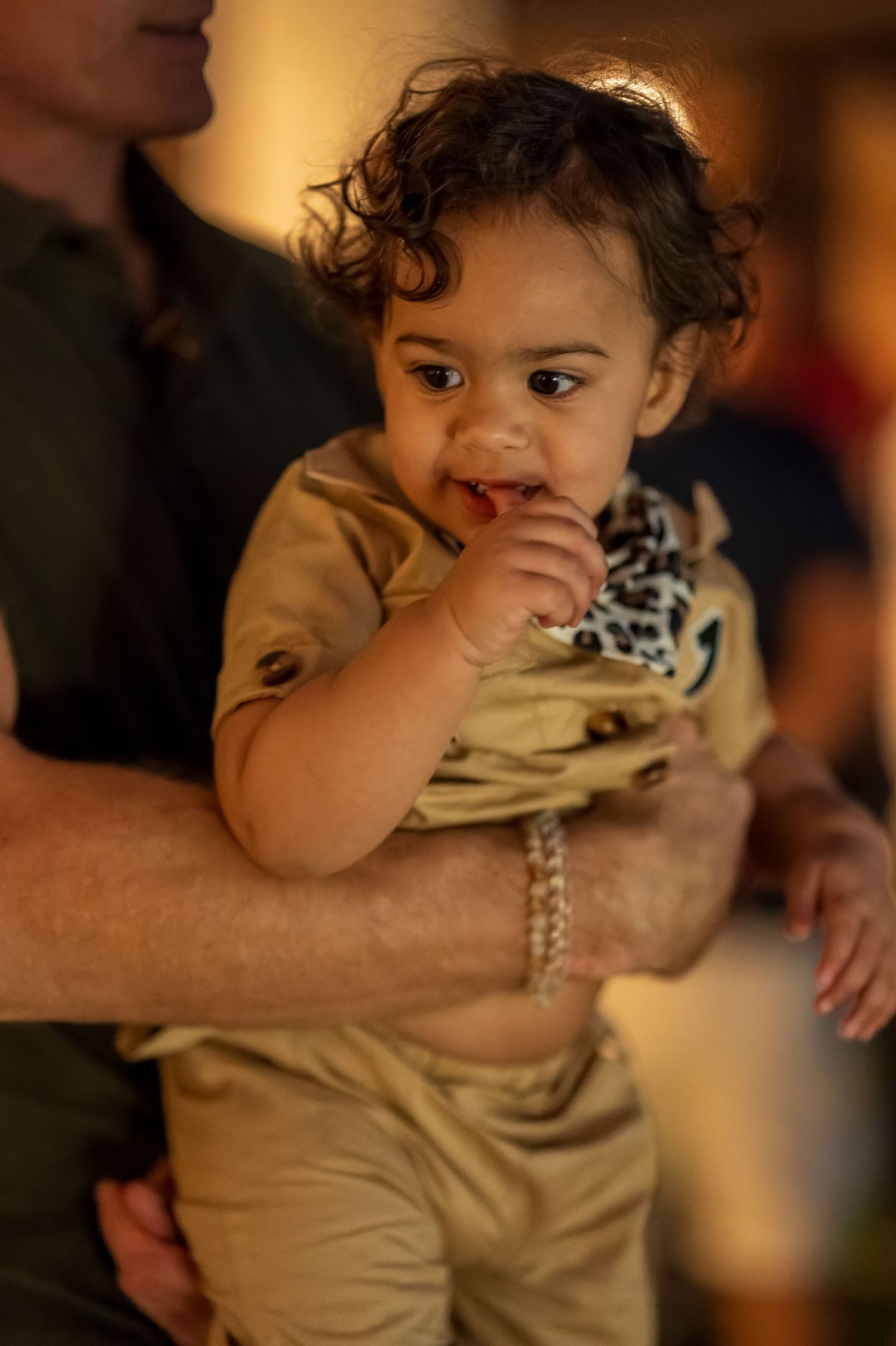 Candid moment captured in warm lighting at a safari-themed celebration.